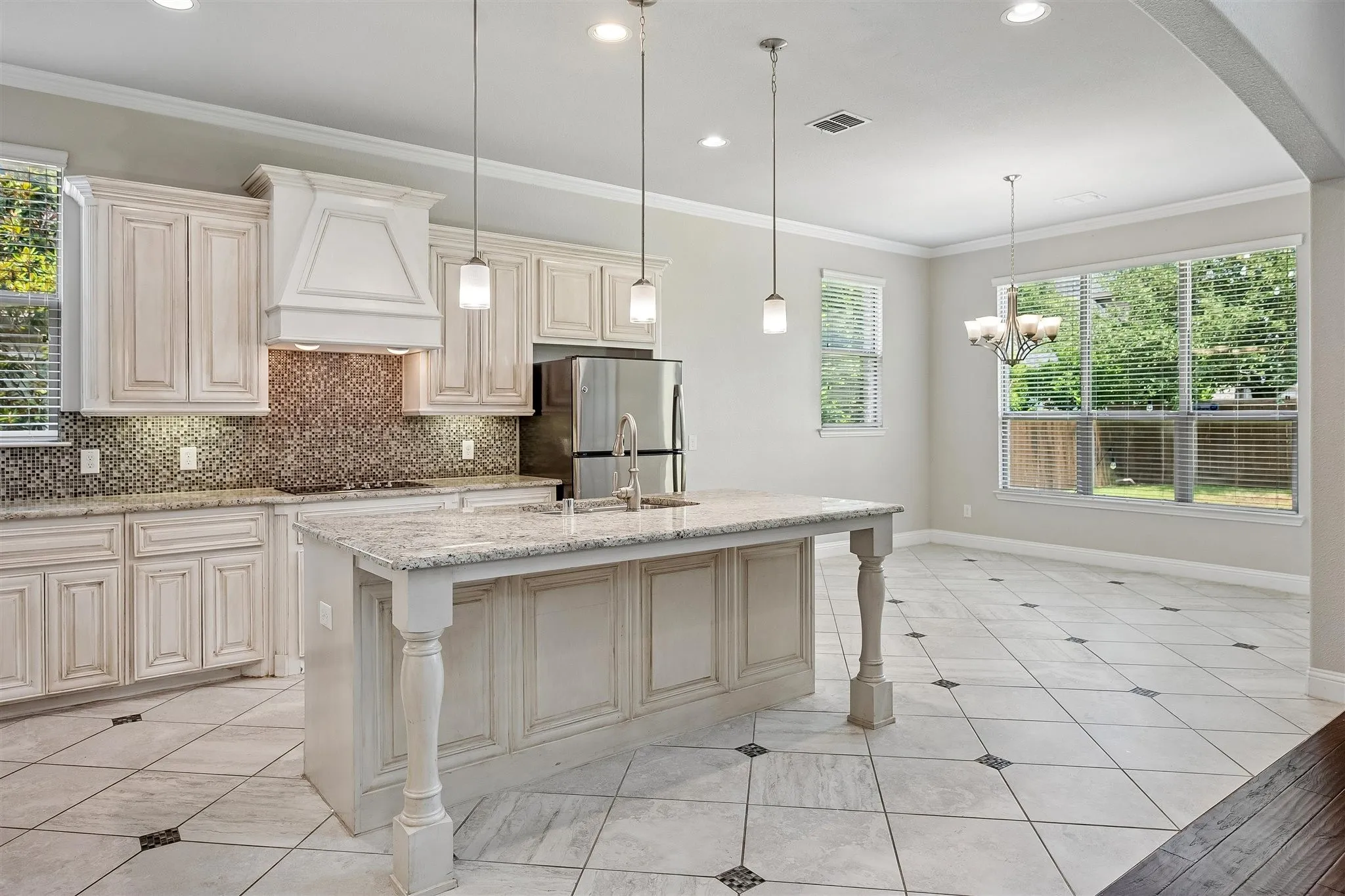 Kitchen with a central island featuring a light-toned countertop and decorative turned legs