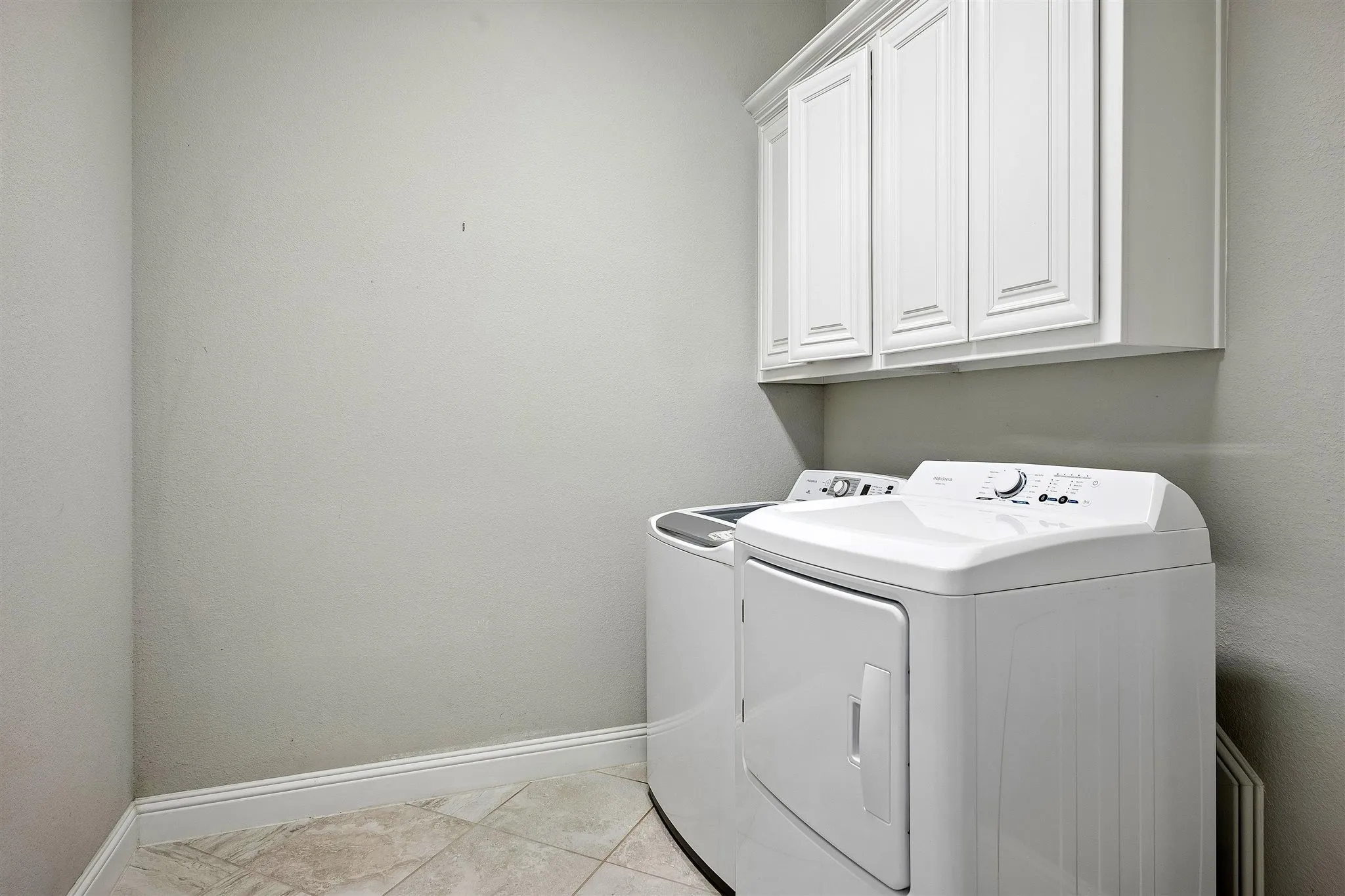 Laundry area - Room for additional refrigraotor - featuring white shaker-style cabinetry