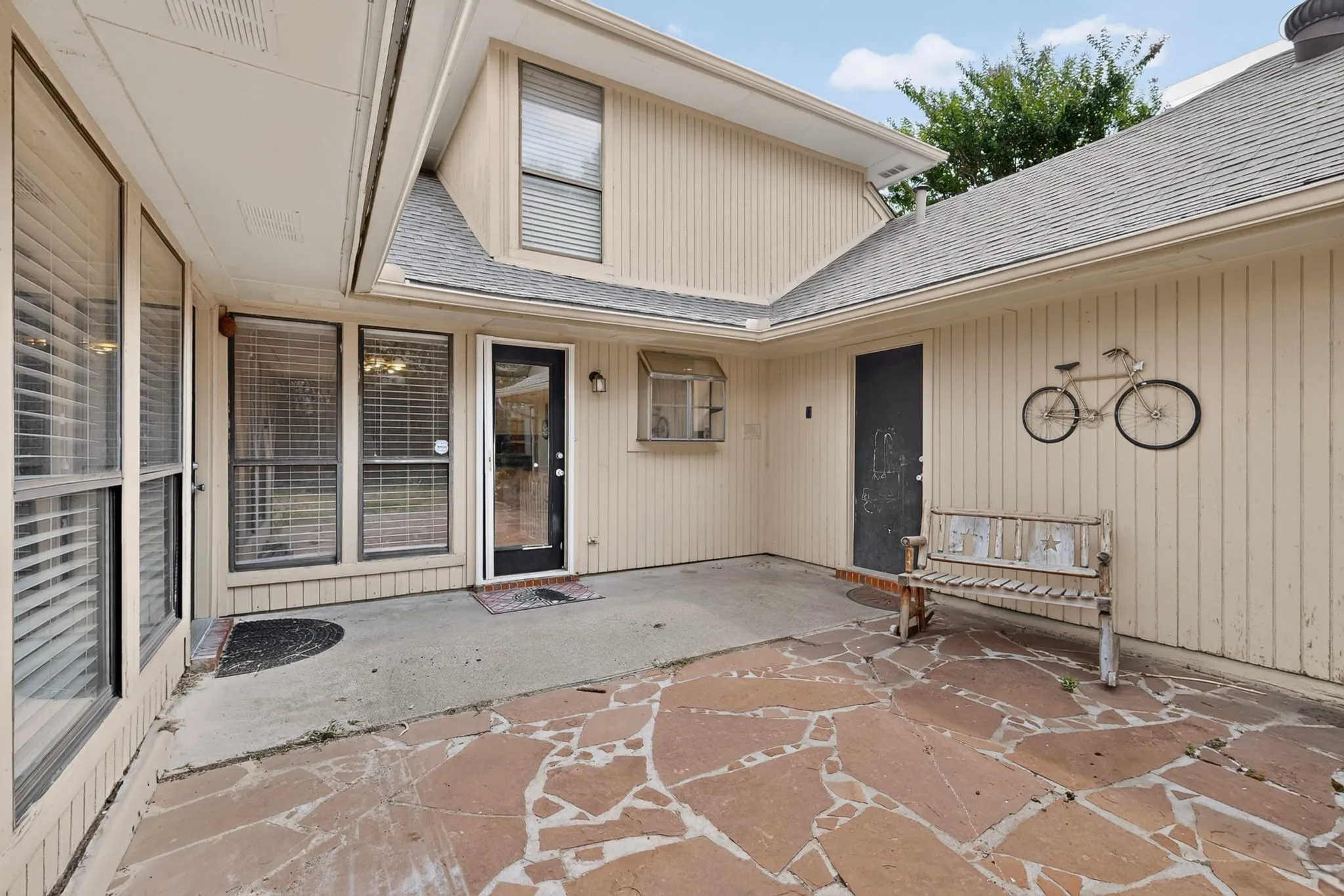 Patio featuring irregular flagstone and concrete paving