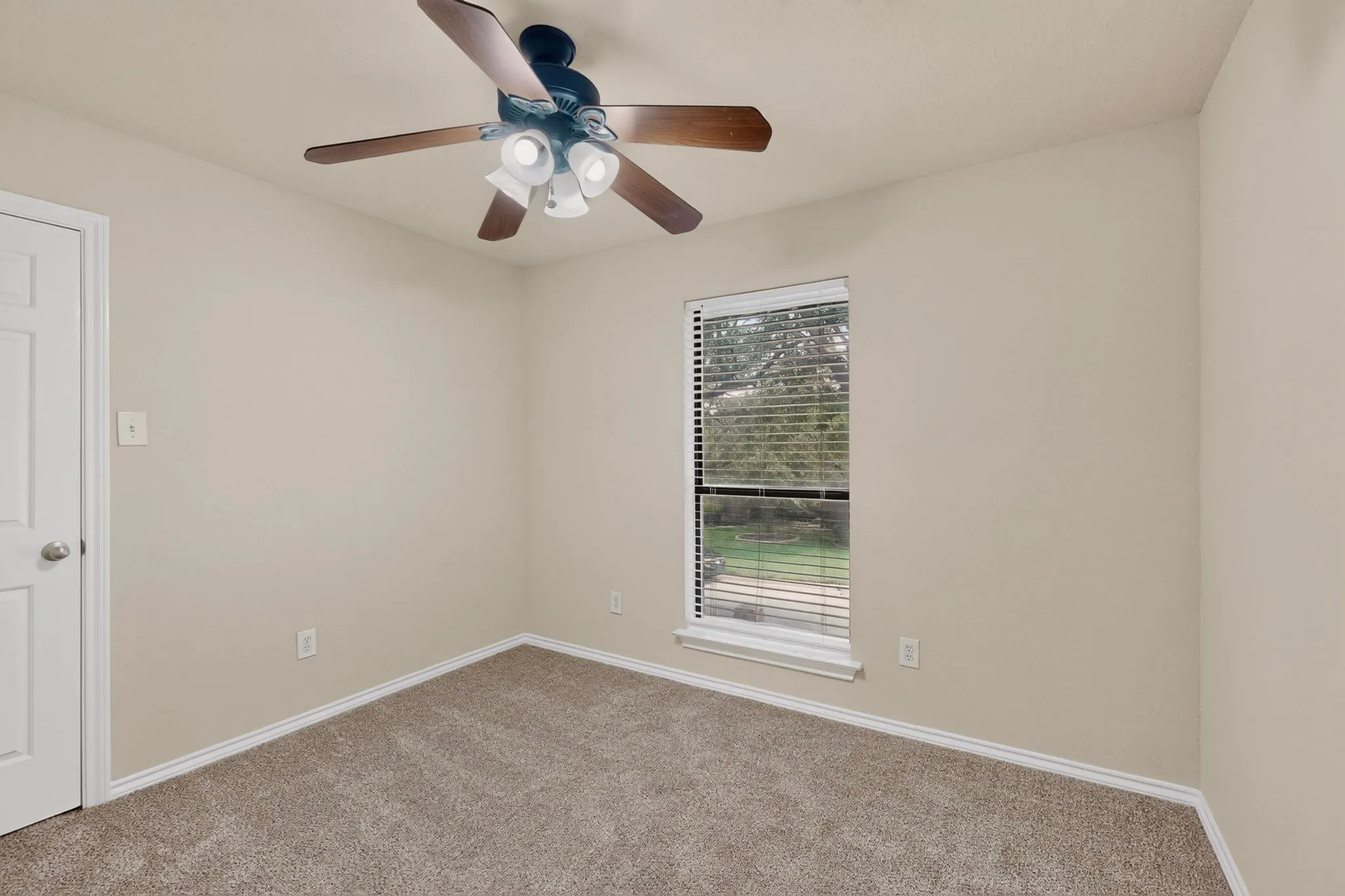 Neutral-toned walls complement the textured carpeting