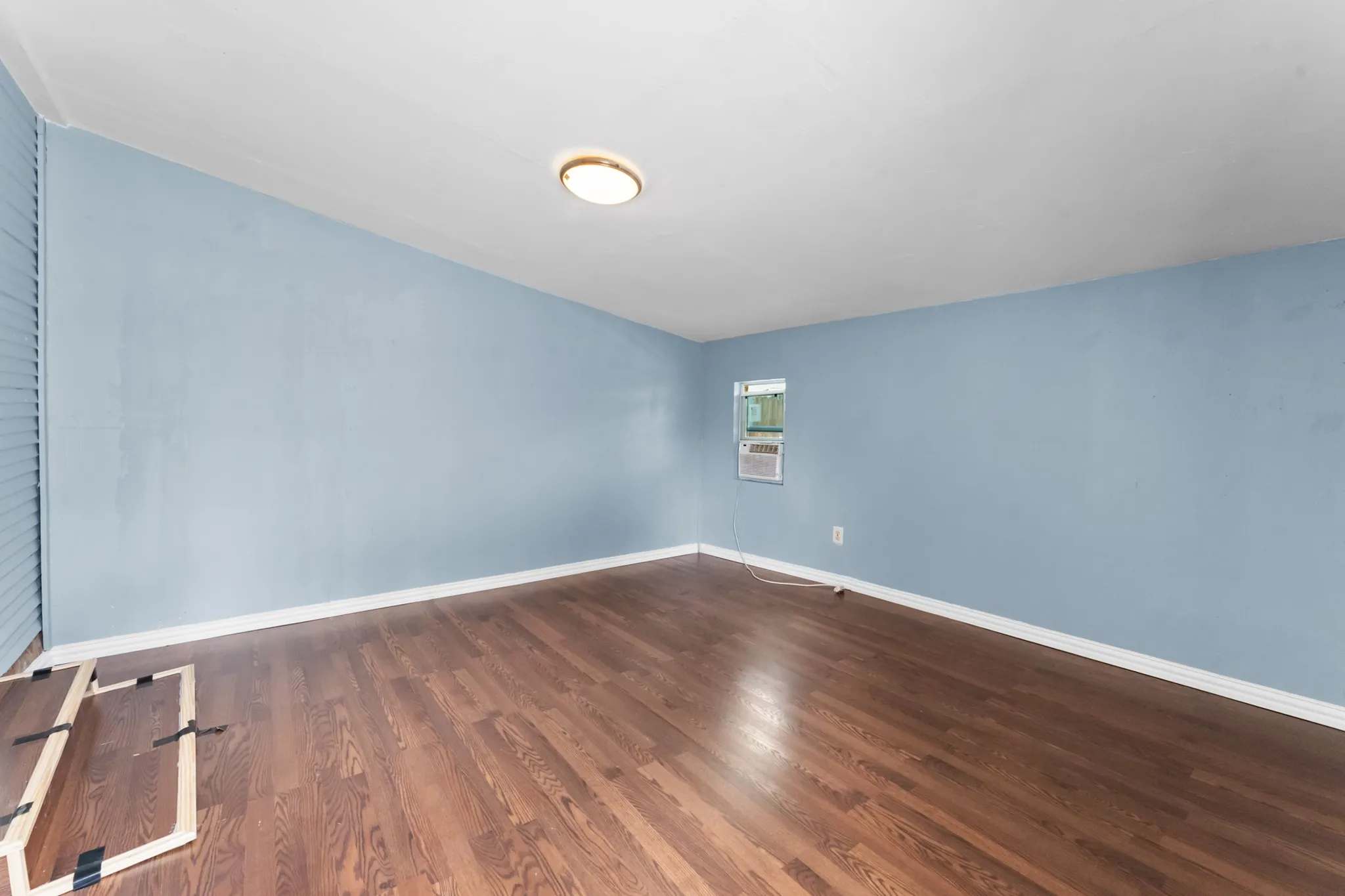 Wood-finish flooring with light blue walls and a white ceiling
