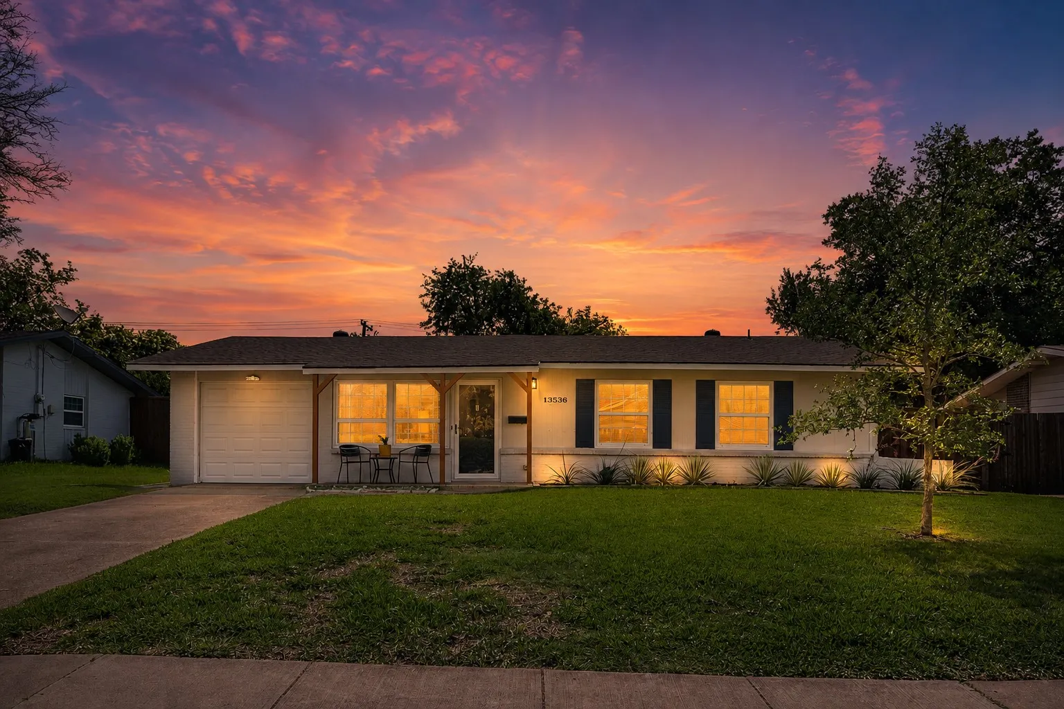 Single-story residence featuring a garage, a concrete driveway, and a front porch