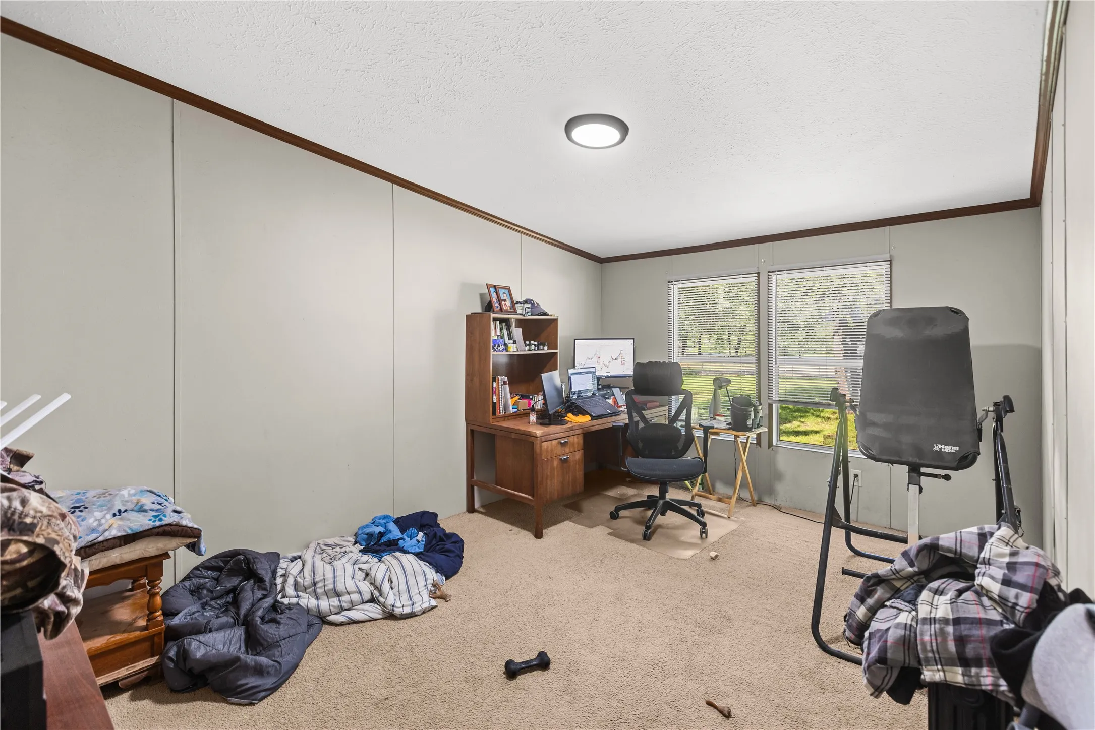 Room featuring two windows, neutral wall paneling, and a recessed ceiling light