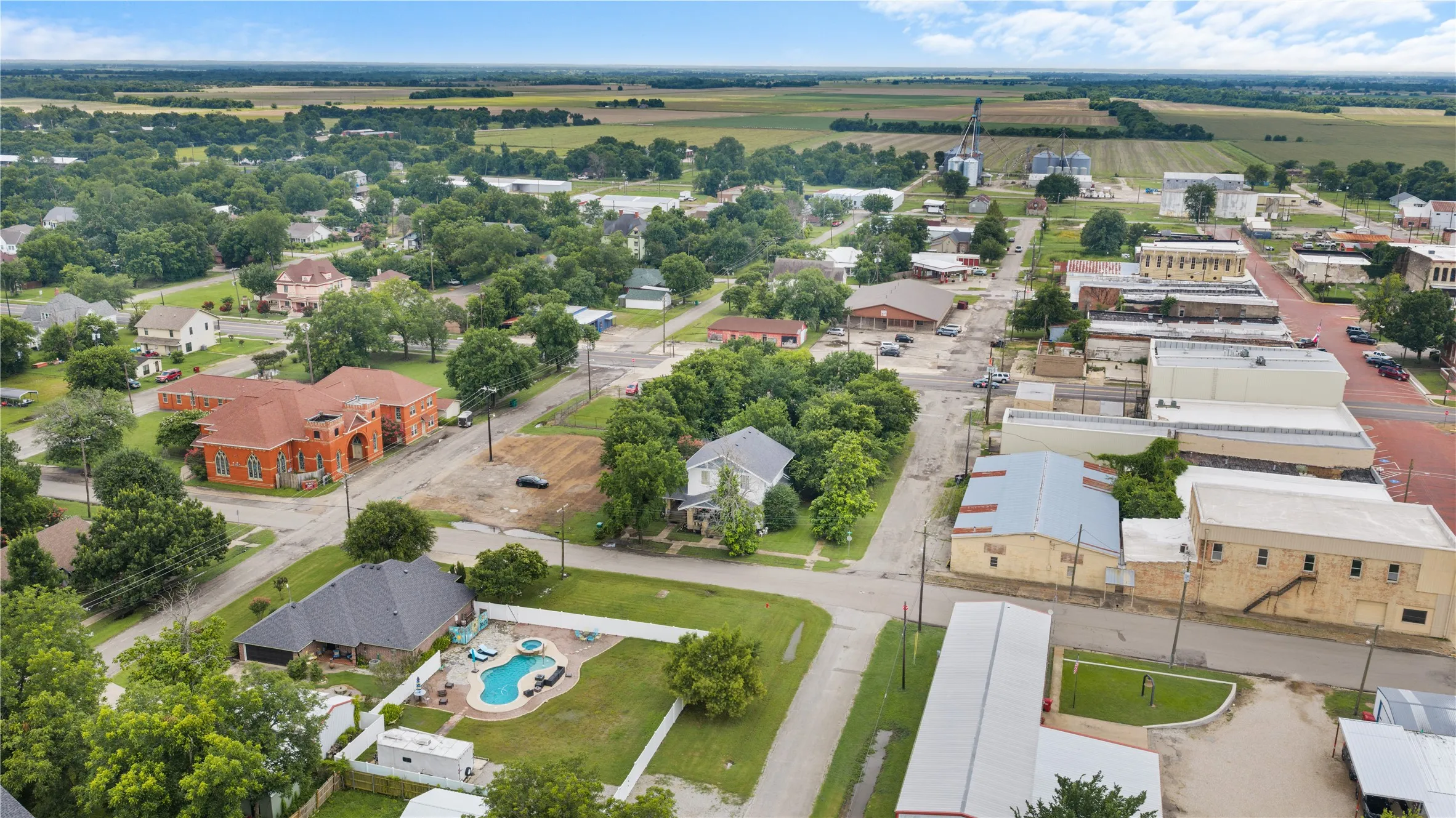 Aerial perspective of a mixed-use neighborhood featuring residential properties and commercial buildings