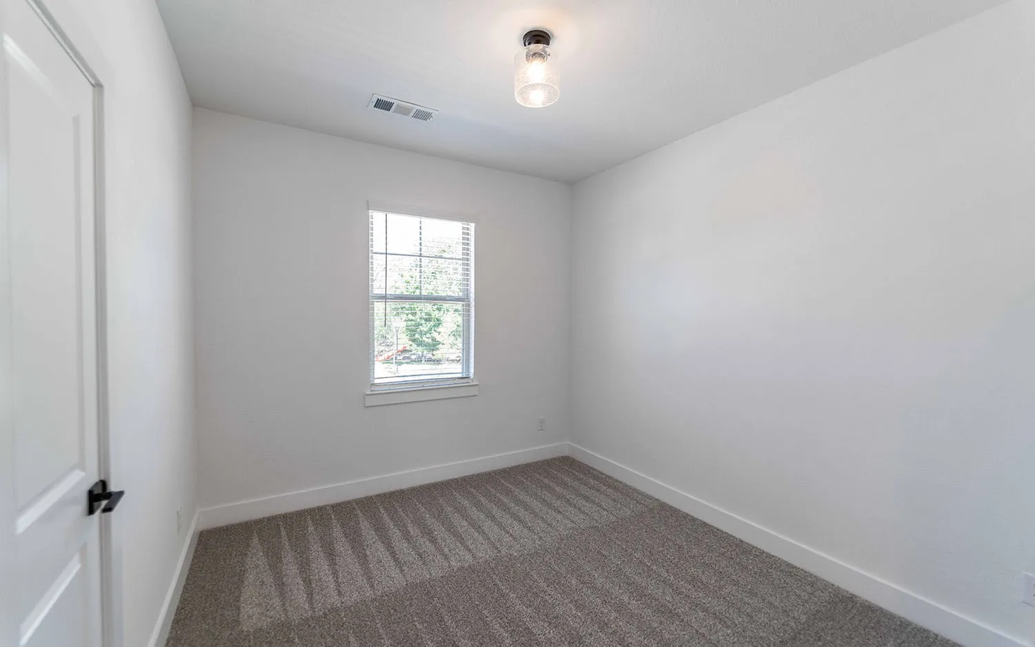 Neutral white walls and patterned grey carpeting