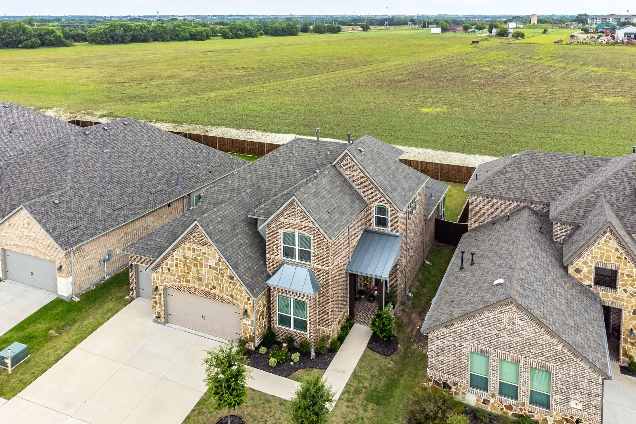 Contemporary two-story residence featuring a combination of brick and stone masonry