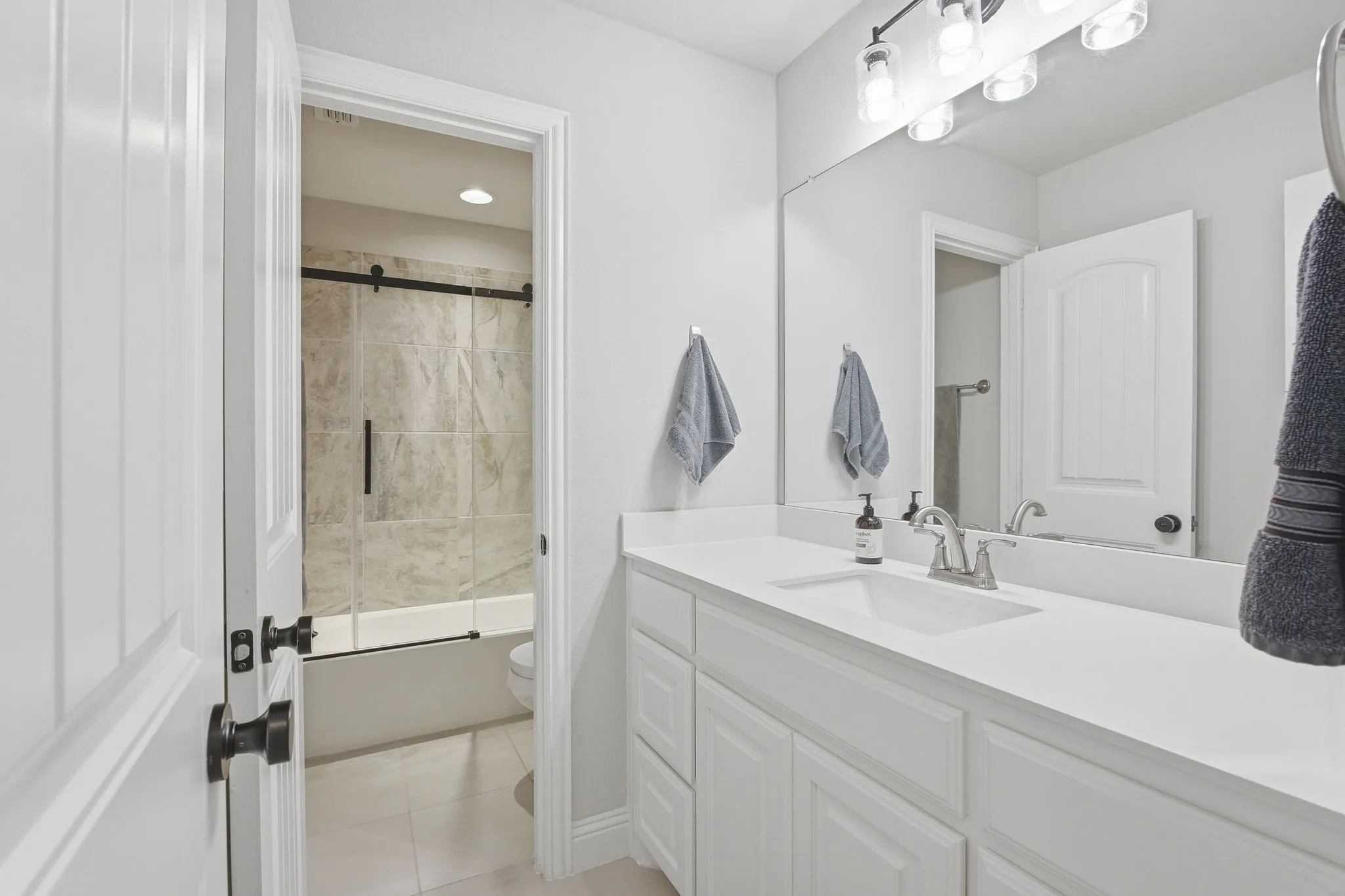 White vanity with integrated sink and chrome faucet