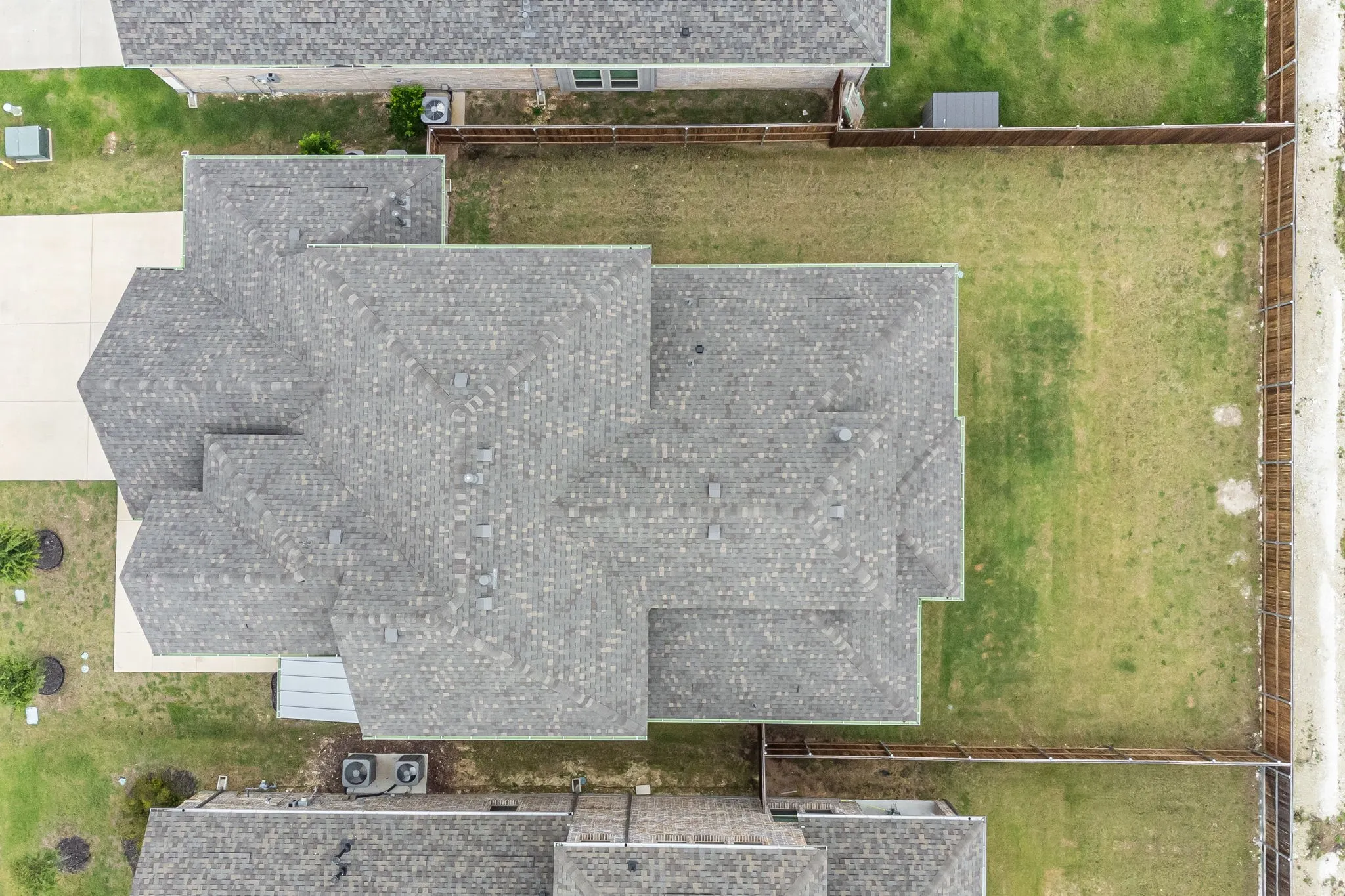 Aerial perspective showcasing a multi-gabled roofline with asphalt shingles