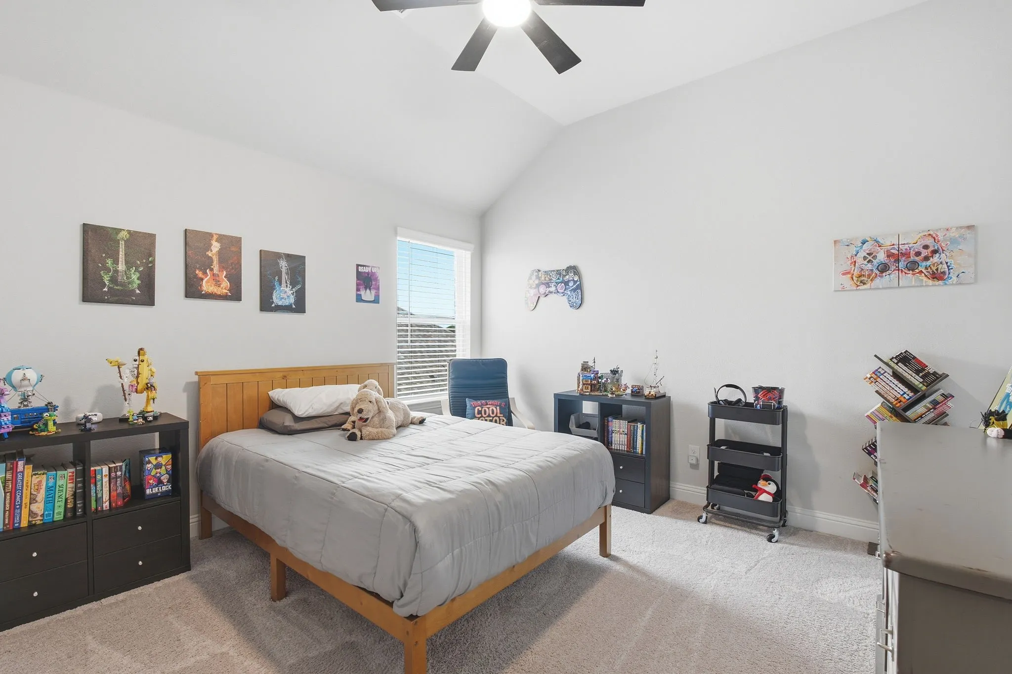 Spacious room featuring vaulted ceilings and light-toned walls