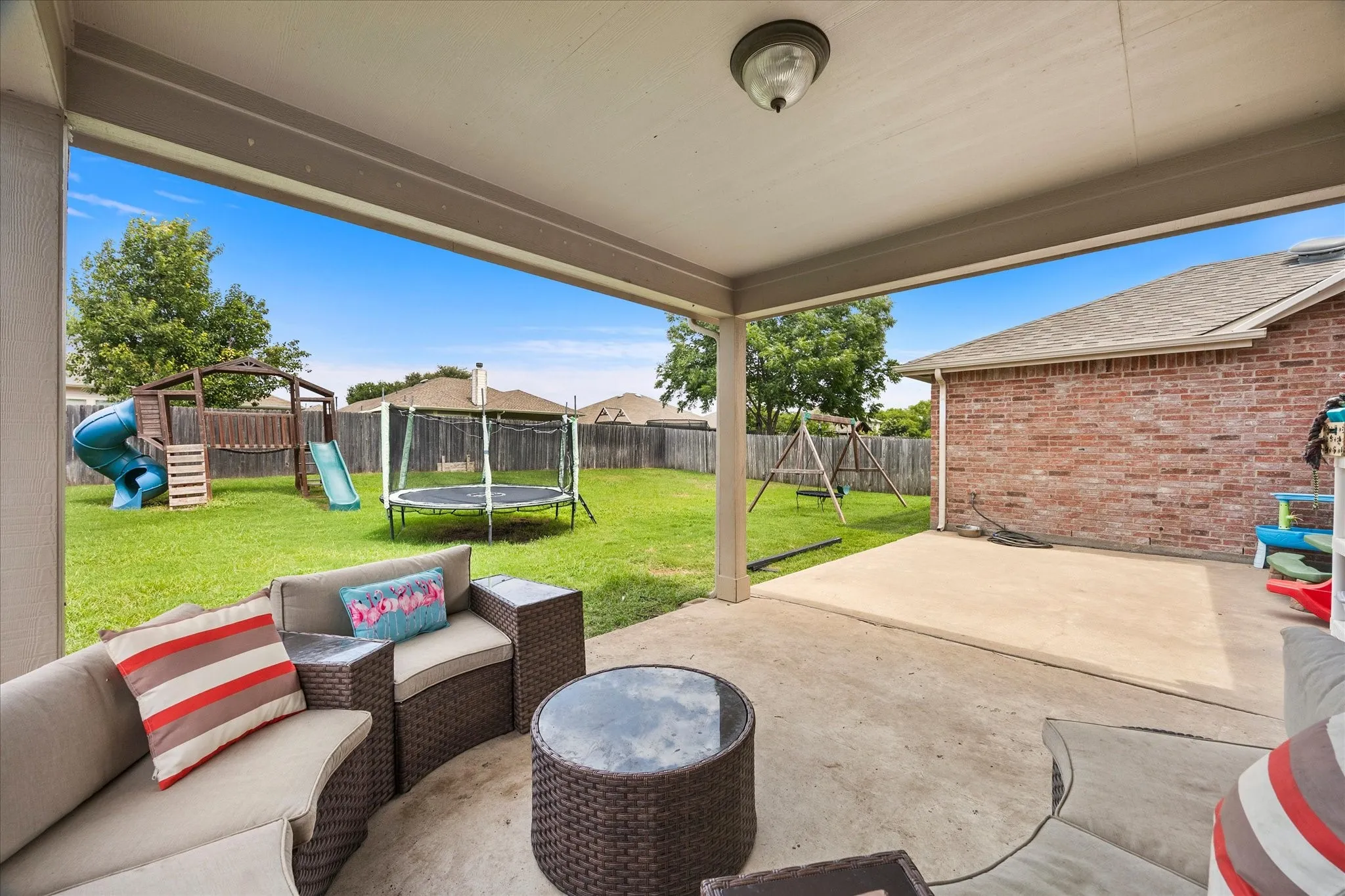 Covered patio featuring concrete flooring and a ceiling light fixture