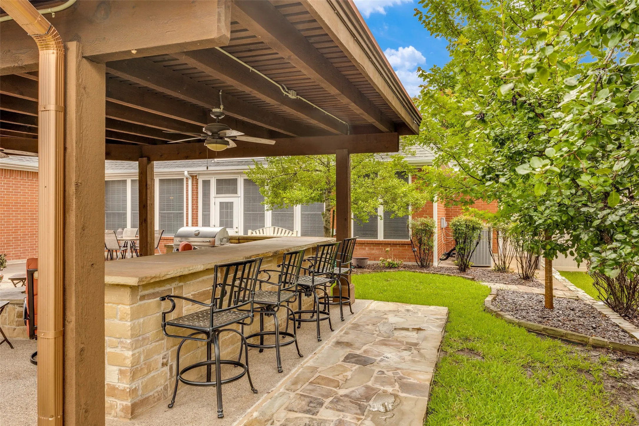 Outdoor living area and kitchen featuring bar seating