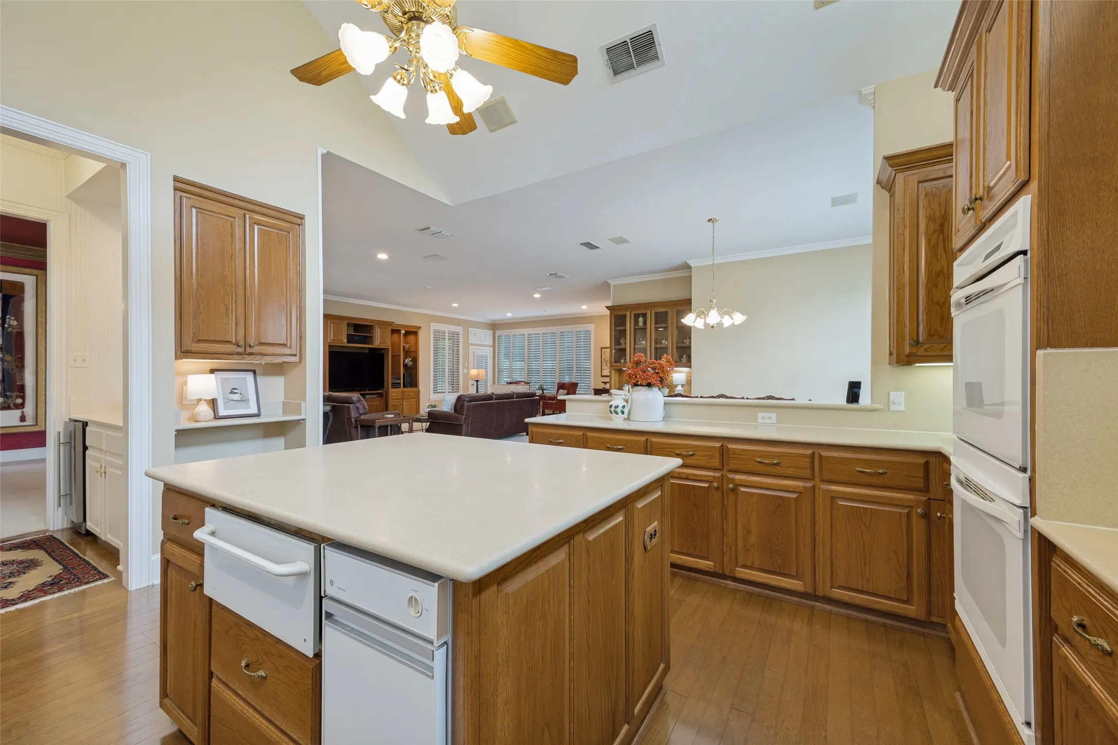 Kitchen featuring warming drawer and trash compactor