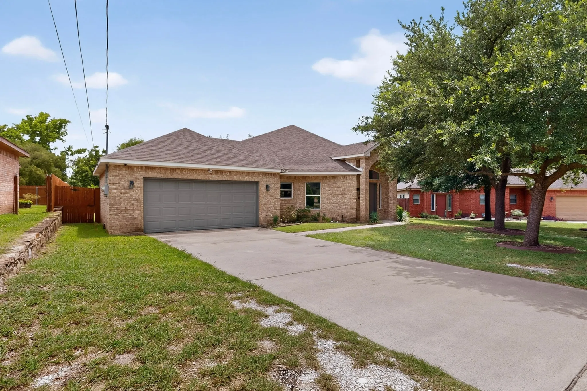 Brick exterior residence featuring a front-facing attached garage