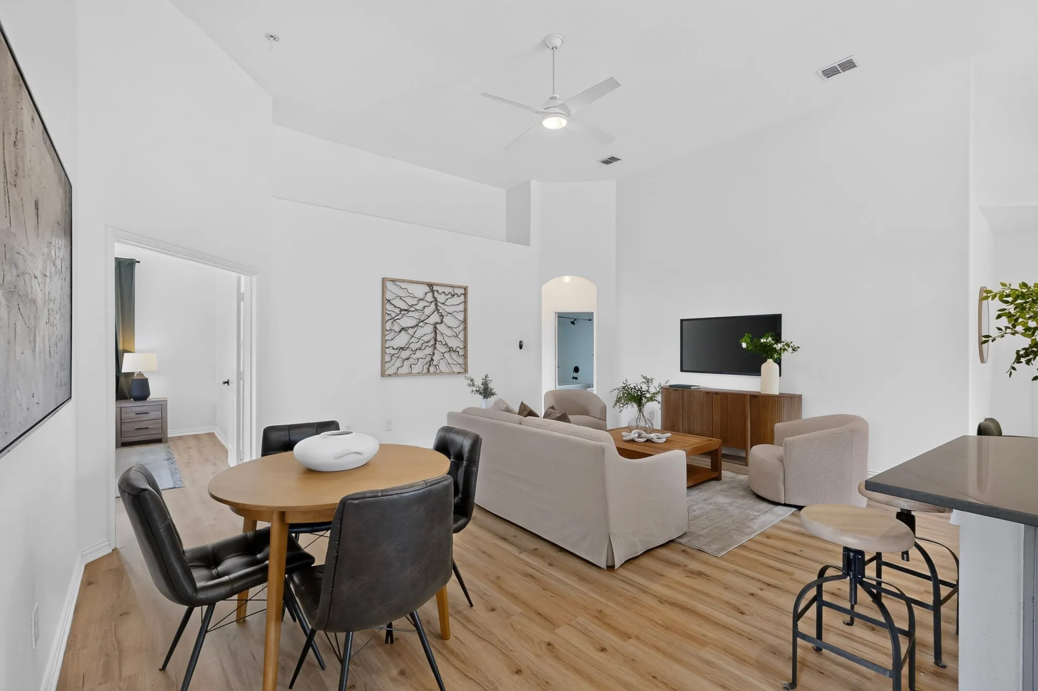 Vaulted ceilings defining a bright interior with wood-finish flooring