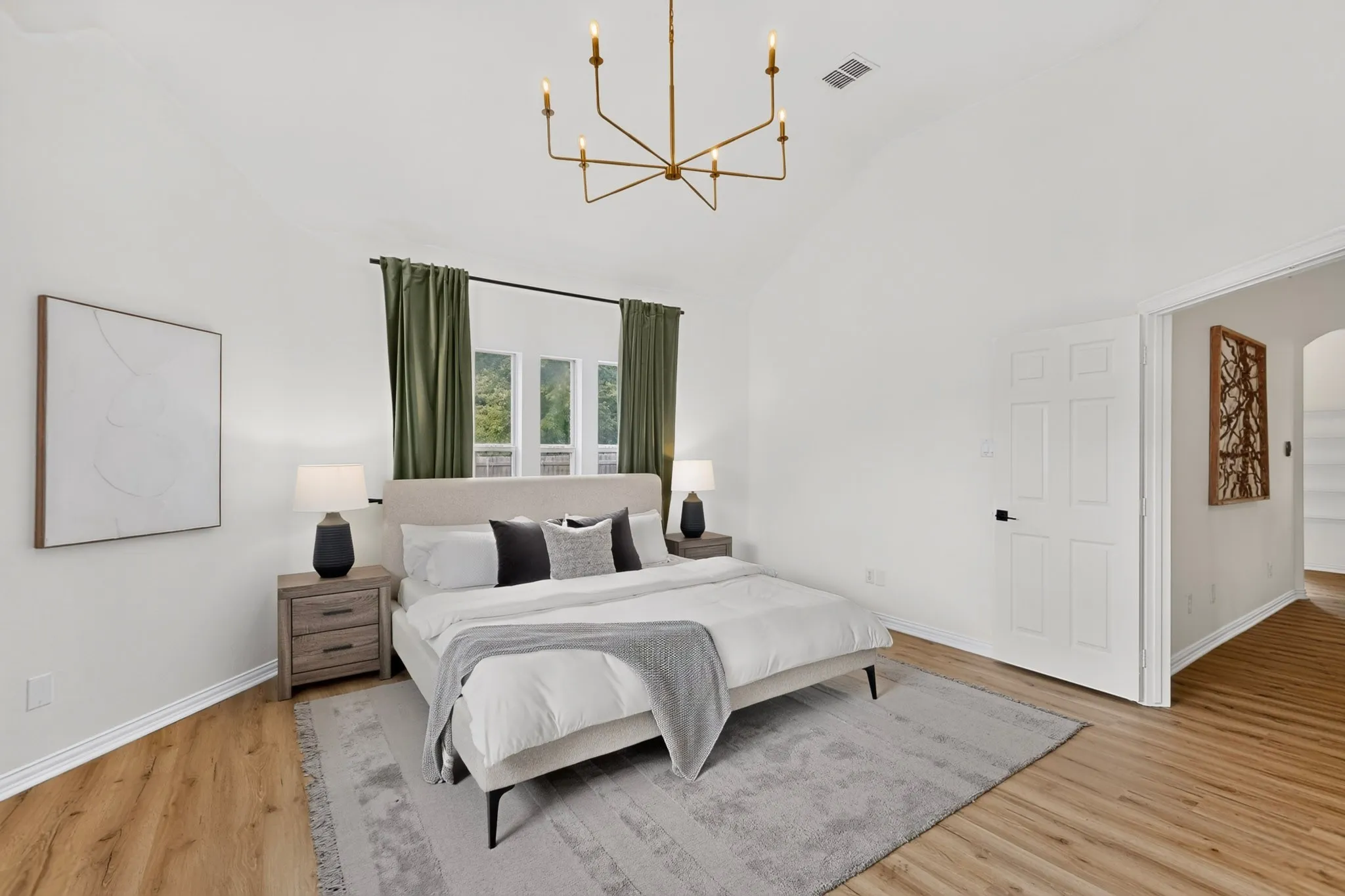 Vaulted ceiling featuring a brass chandelier