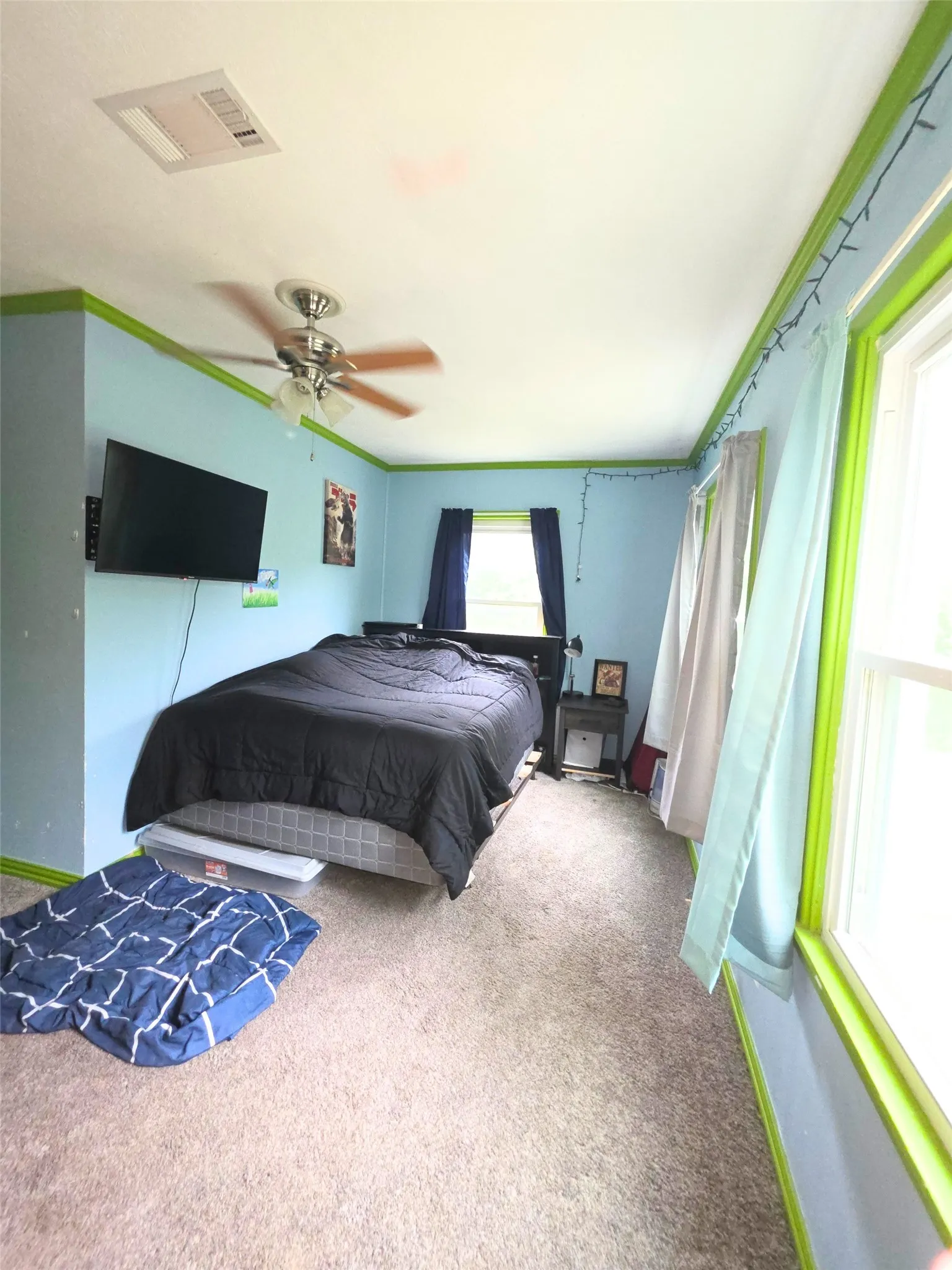 Bedroom featuring soft-tone carpeting and light blue walls