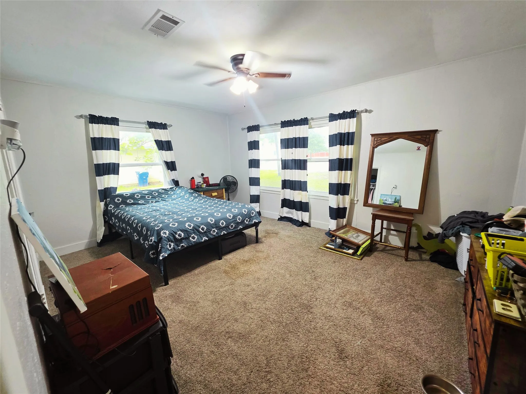 Spacious room featuring neutral carpeting and white walls