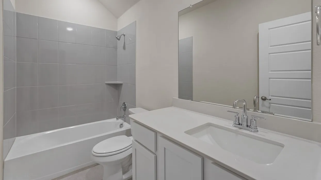 Bathroom featuring a white vanity with an integrated sink, polished chrome faucet, and expansive​​‌​​​​‌​​‌‌​‌‌​​​‌‌​‌​‌​‌​​​‌​​ mirror