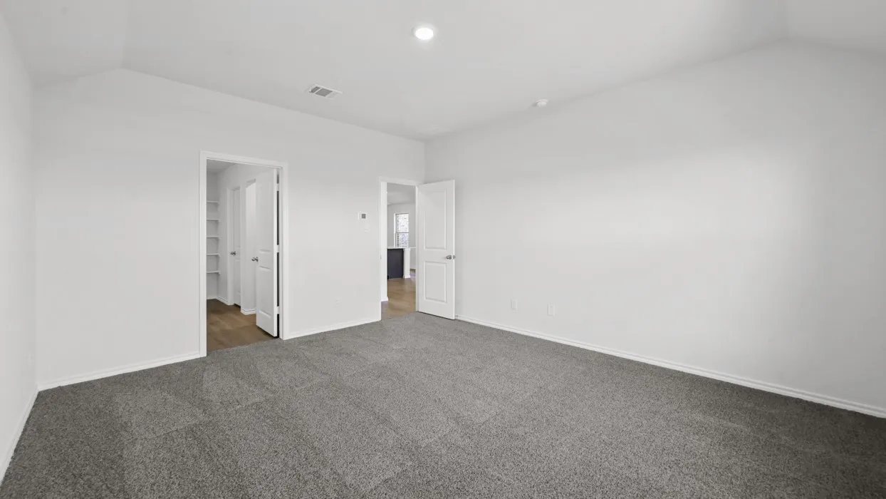 Spacious room with vaulted ceilings and neutral wall tones