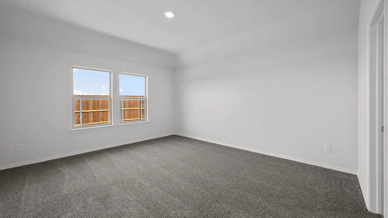 Spacious interior room featuring neutral wall paint, gray carpet flooring, two windows with white trim, and recessed ceiling lighting