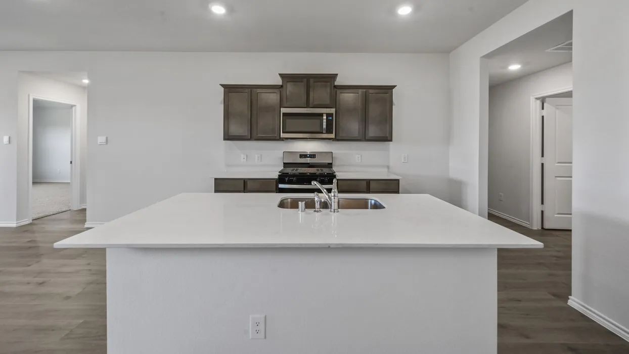 Kitchen island featuring a stainless steel undermount sink and a polished chrome faucet