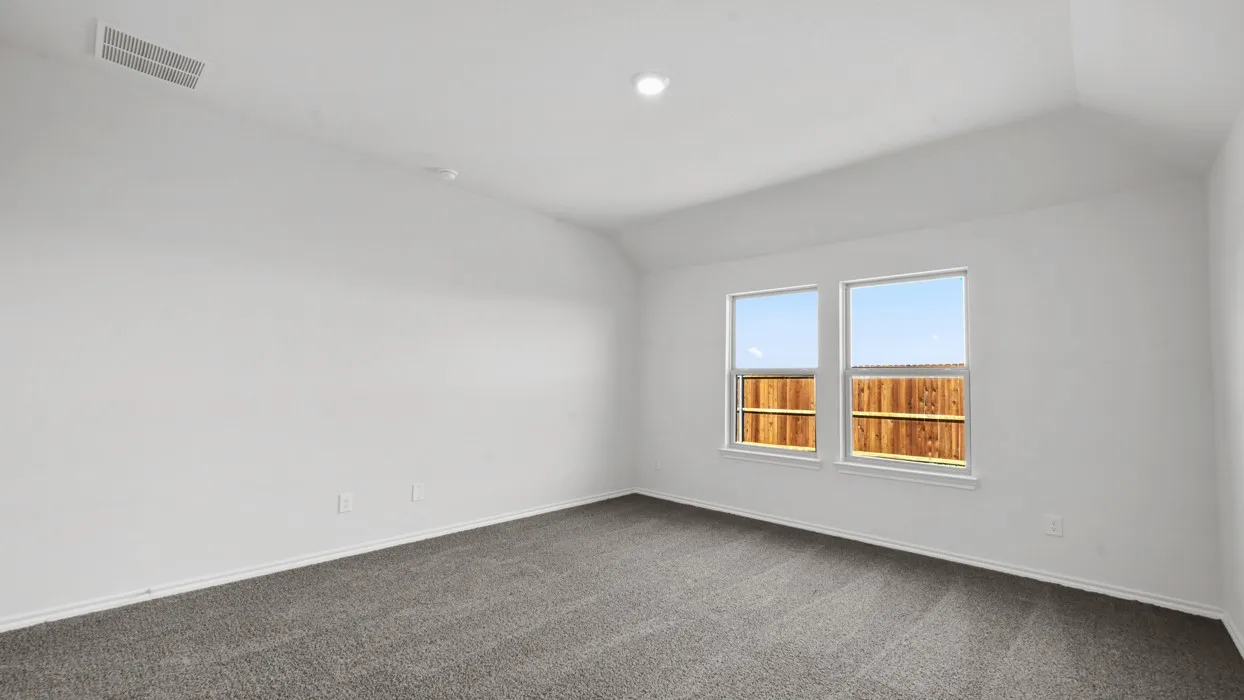 Spacious room featuring neutral carpeting and white walls