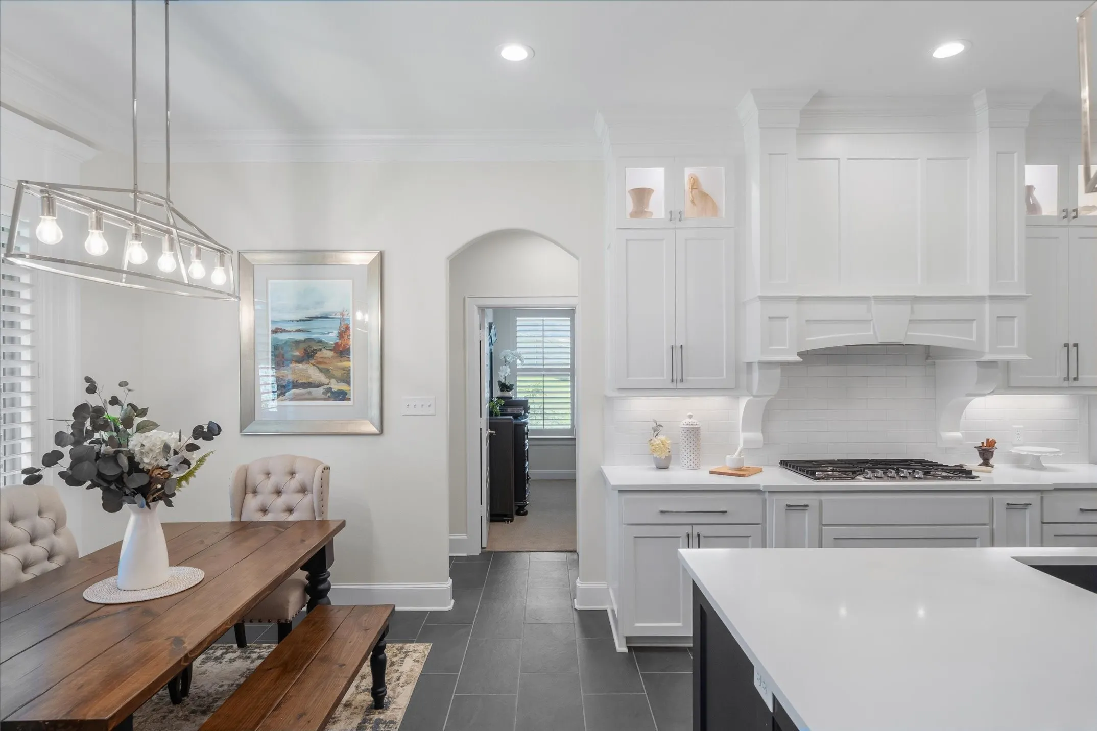 Breakfast nook just off the kitchen has great backyard views and the upper lighted glass front cabinets shown here
