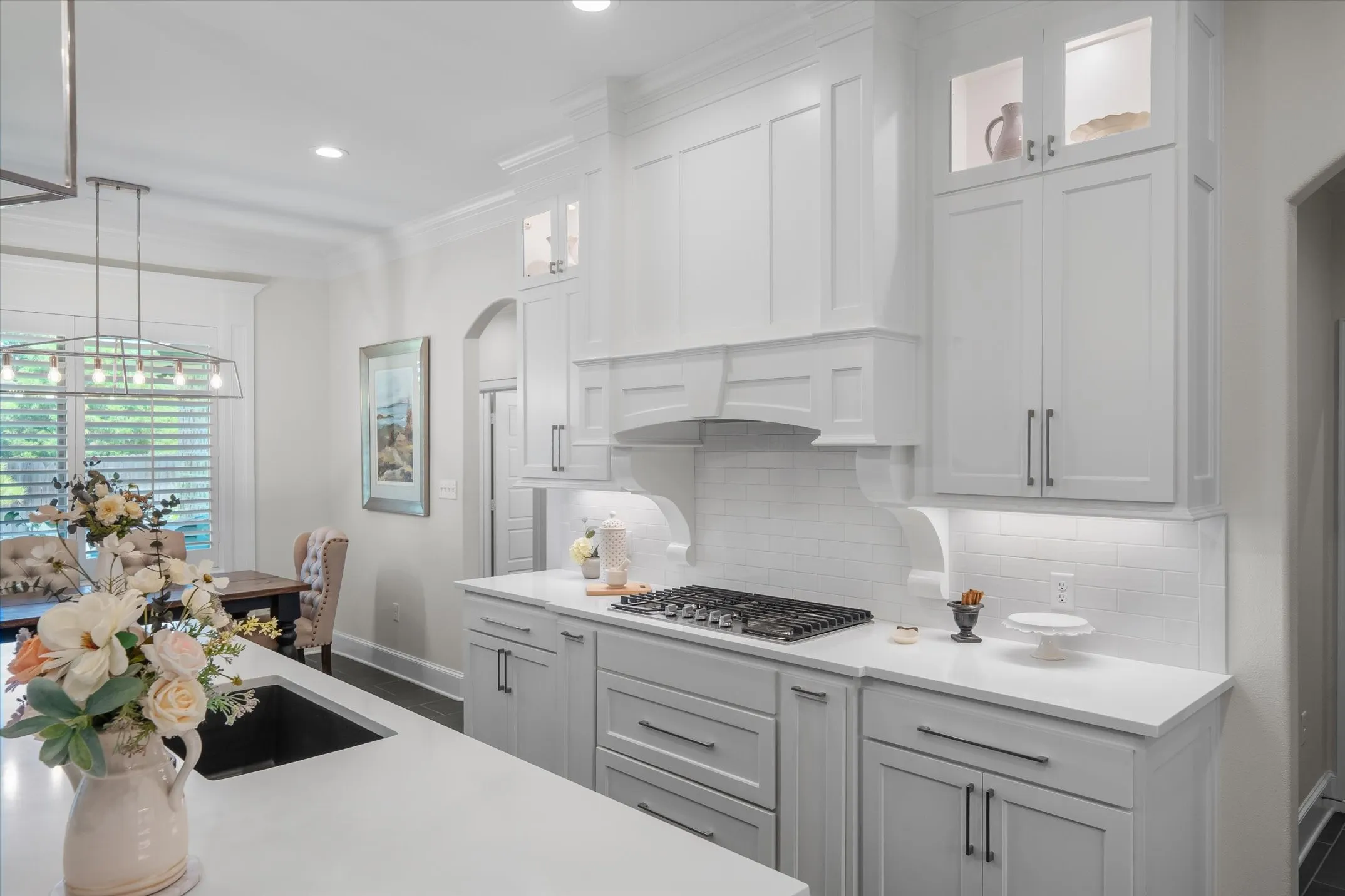 Gas cook top, quartz, cabinets to the ceiling, upper lighted cabinets, custom Venta hood, under cabinet lighting all the details that keeps one admiring this kitcen