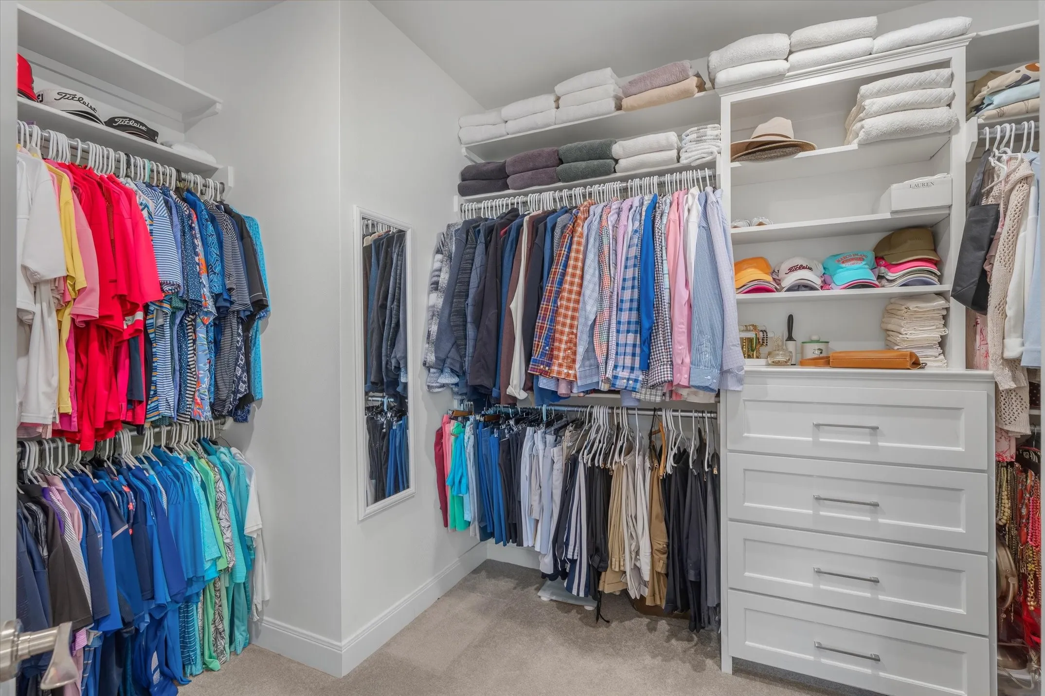 Primary walk in closet with built in chest