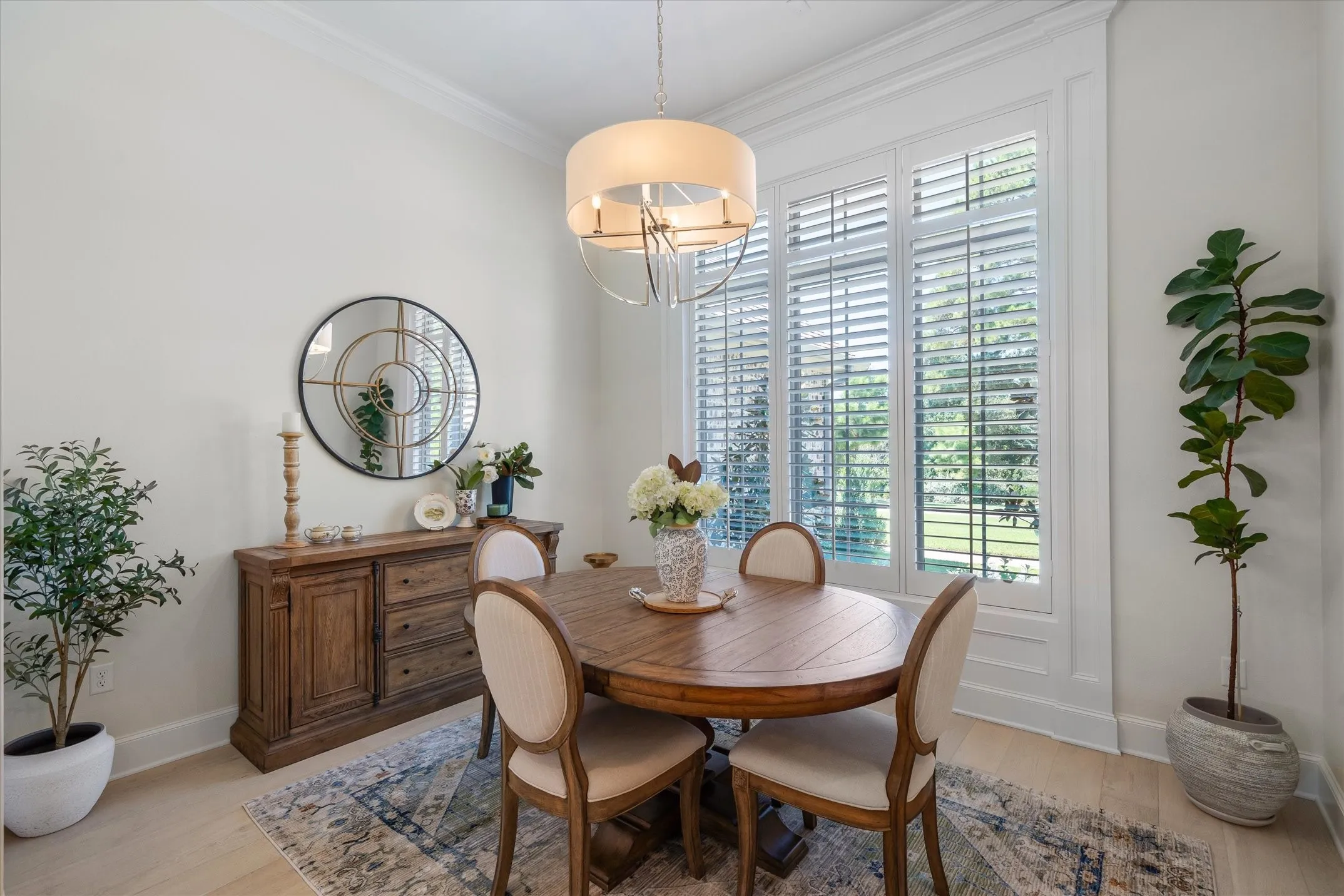 Plantation shutters give this east TX home the perfect French country look that we all love. Formal dining has beautiful views of the spring fed lake