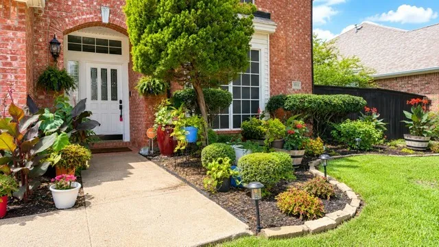 Brick exterior featuring an arched entryway with a white paneled door