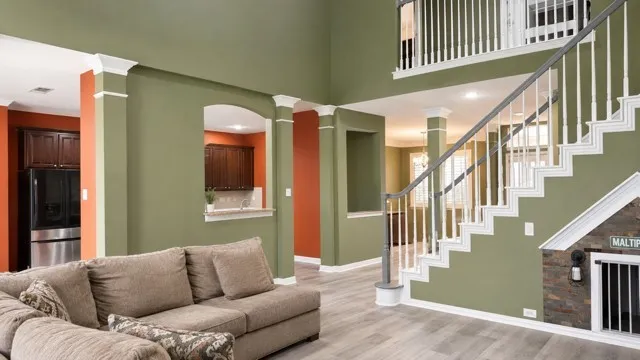 Two-story living area with wood-finish flooring and recessed lighting