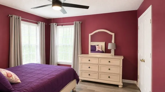 Interior room featuring wood-finish flooring and two windows with blinds