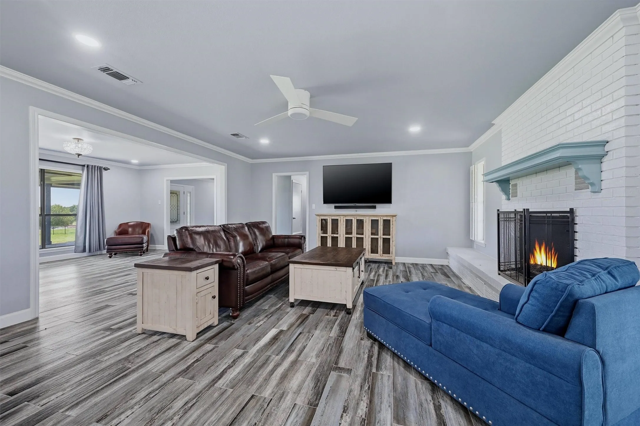 Living area is spacious - complete with a fireplace and celing fan.