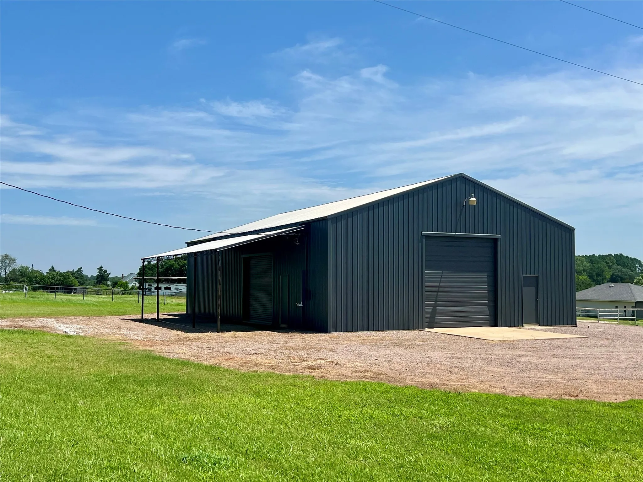 Overhang on the north side of the shop is great for parking trailers or equipment.