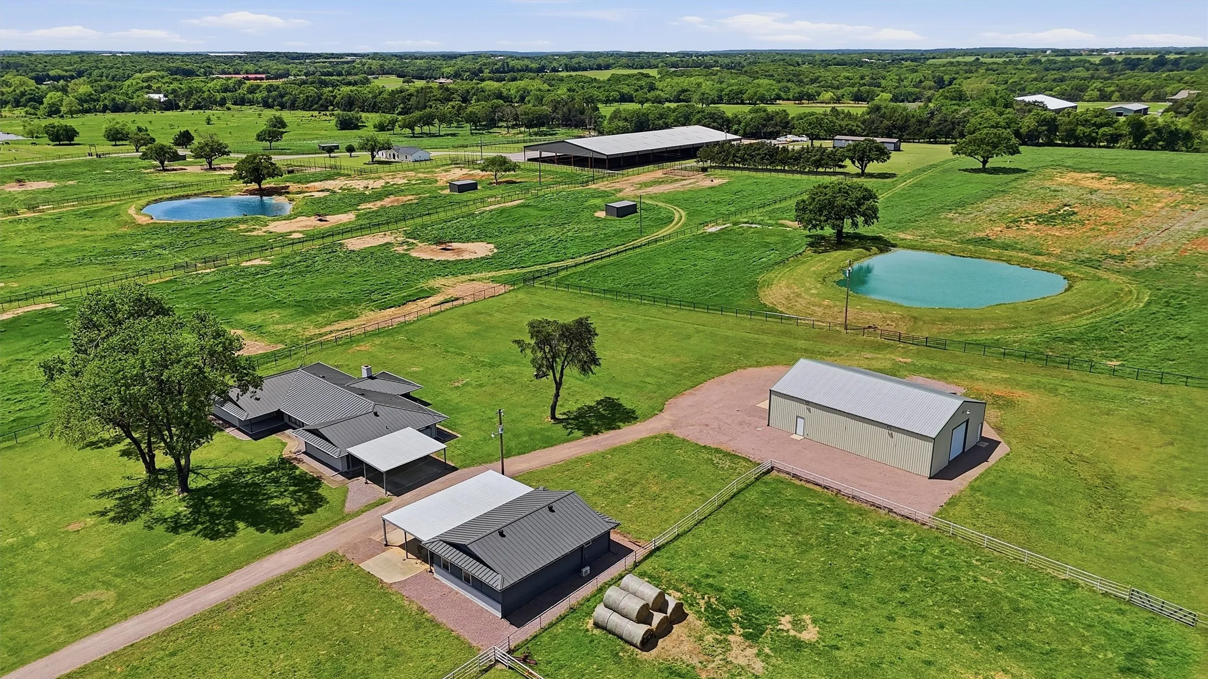 Aerial view showing home, detached tool shed/garage and shop.