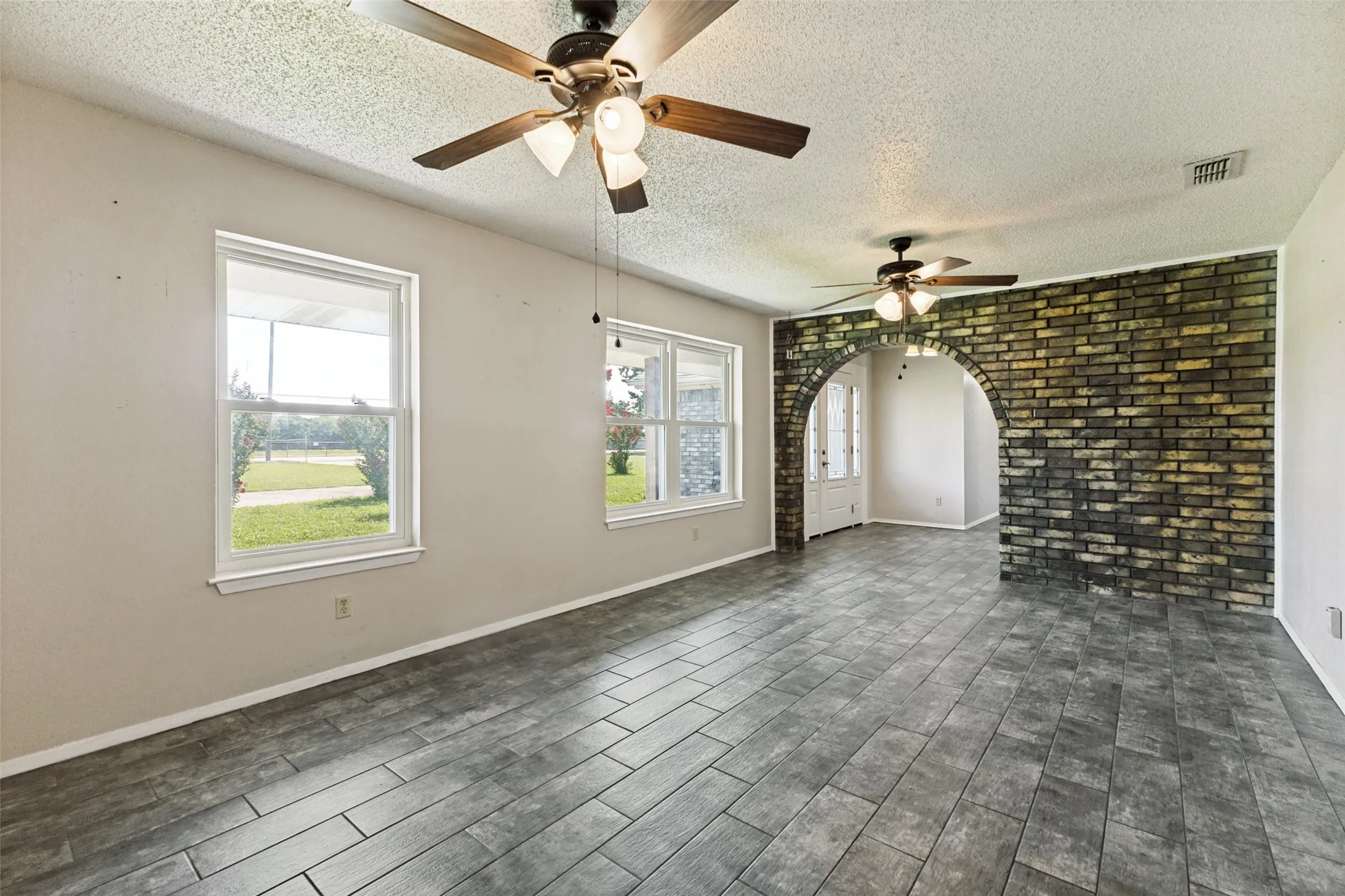 Stacked formal living & dining with a beautiful brick accent wall