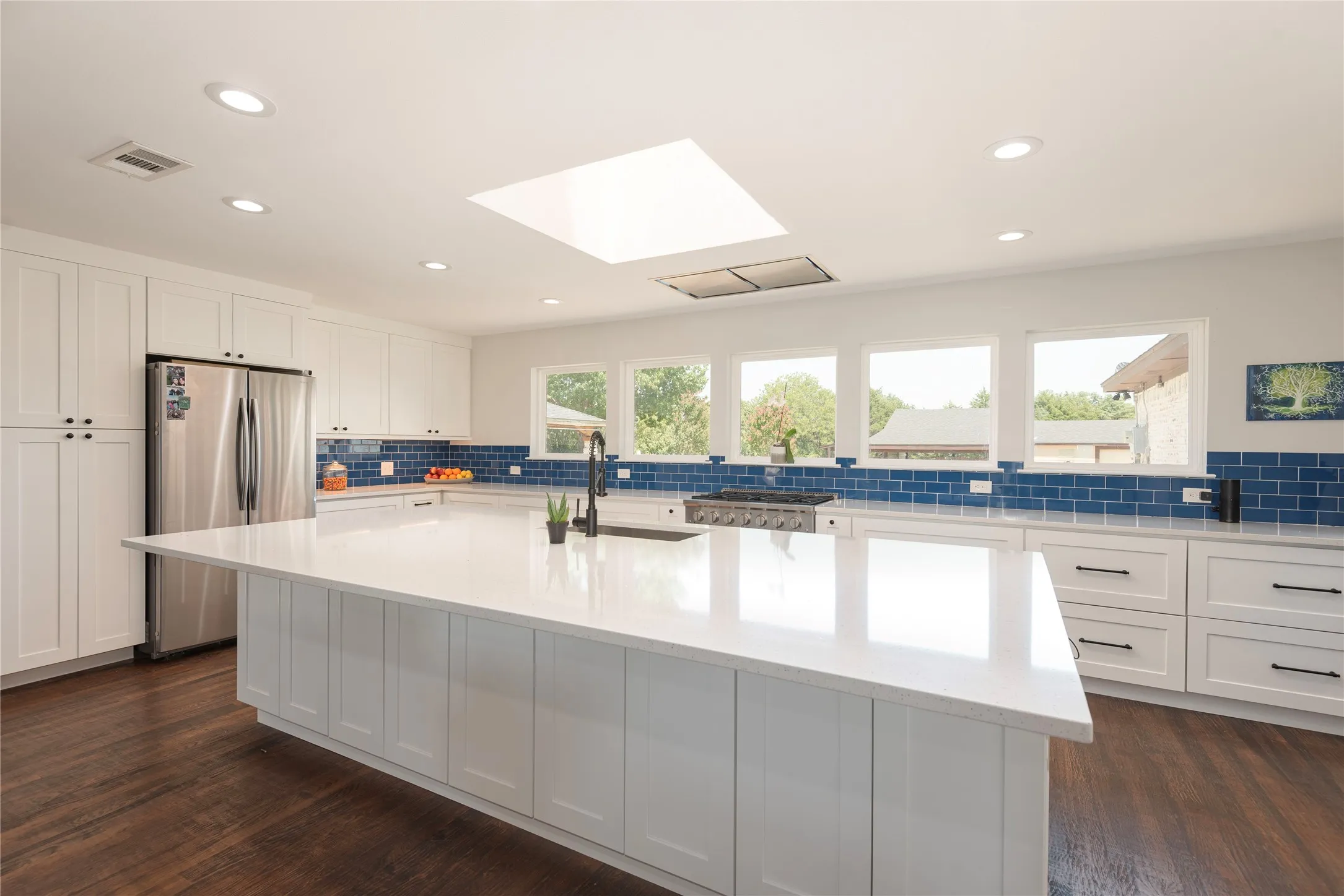 Kitchen overlooks pool and backyard