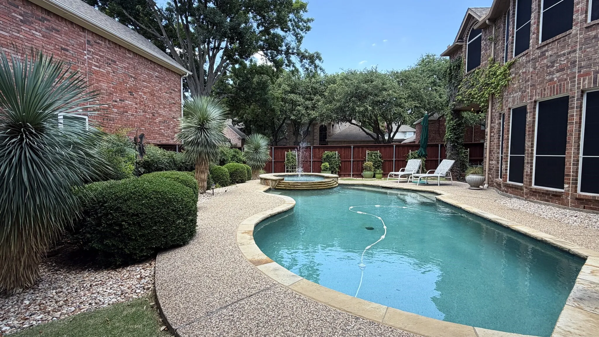 Beautifully landscaped backyard. Large yard with pool and mature landscape.