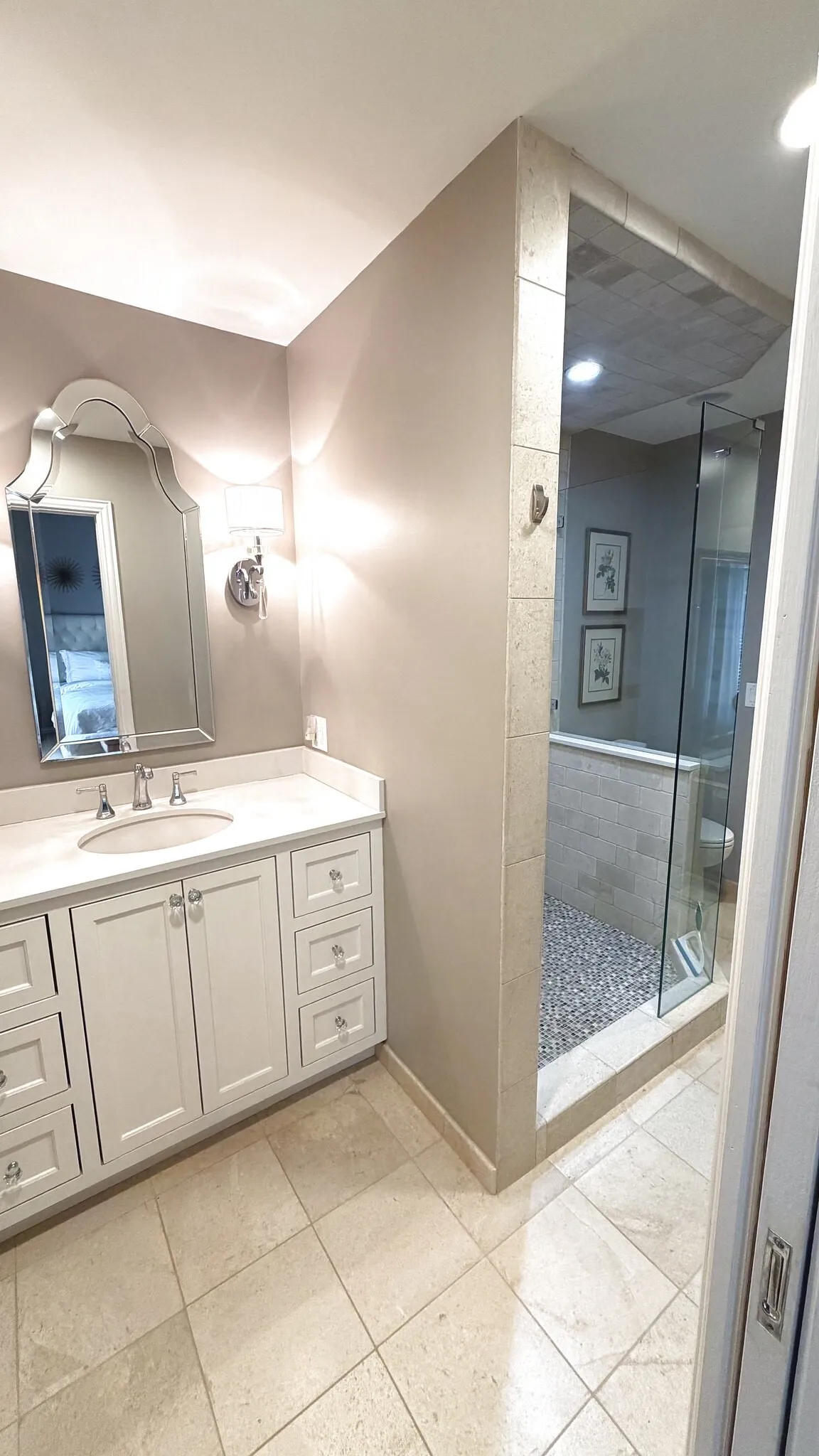 Bedroom en-suite jack and jill bathroom with updated counters, built in cabinets, standing shower