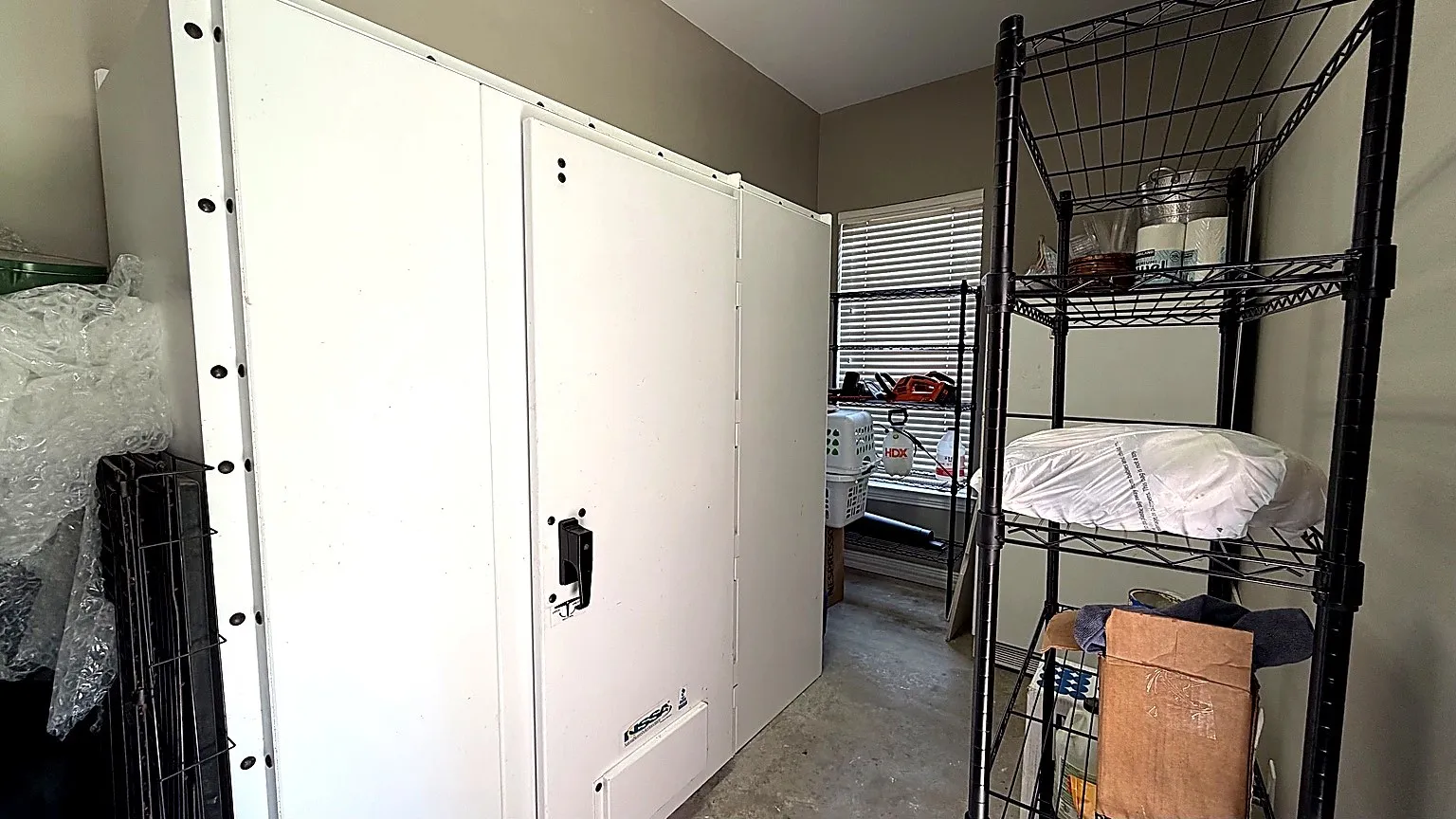 bonus storage area off the garage with a built in storm shelter for 2, large storage area