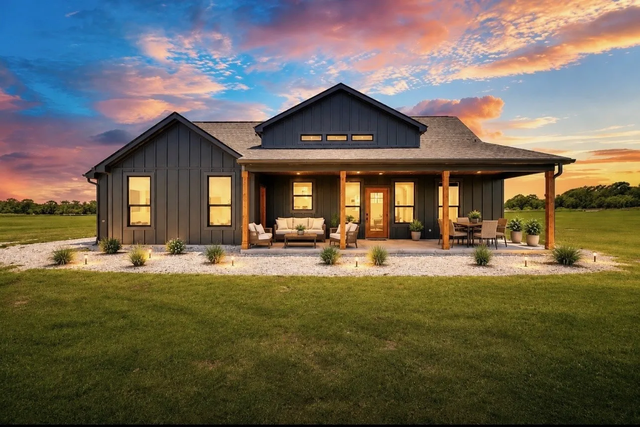 Contemporary exterior with dark vertical siding, a covered concrete patio, and a wood-paneled entry door