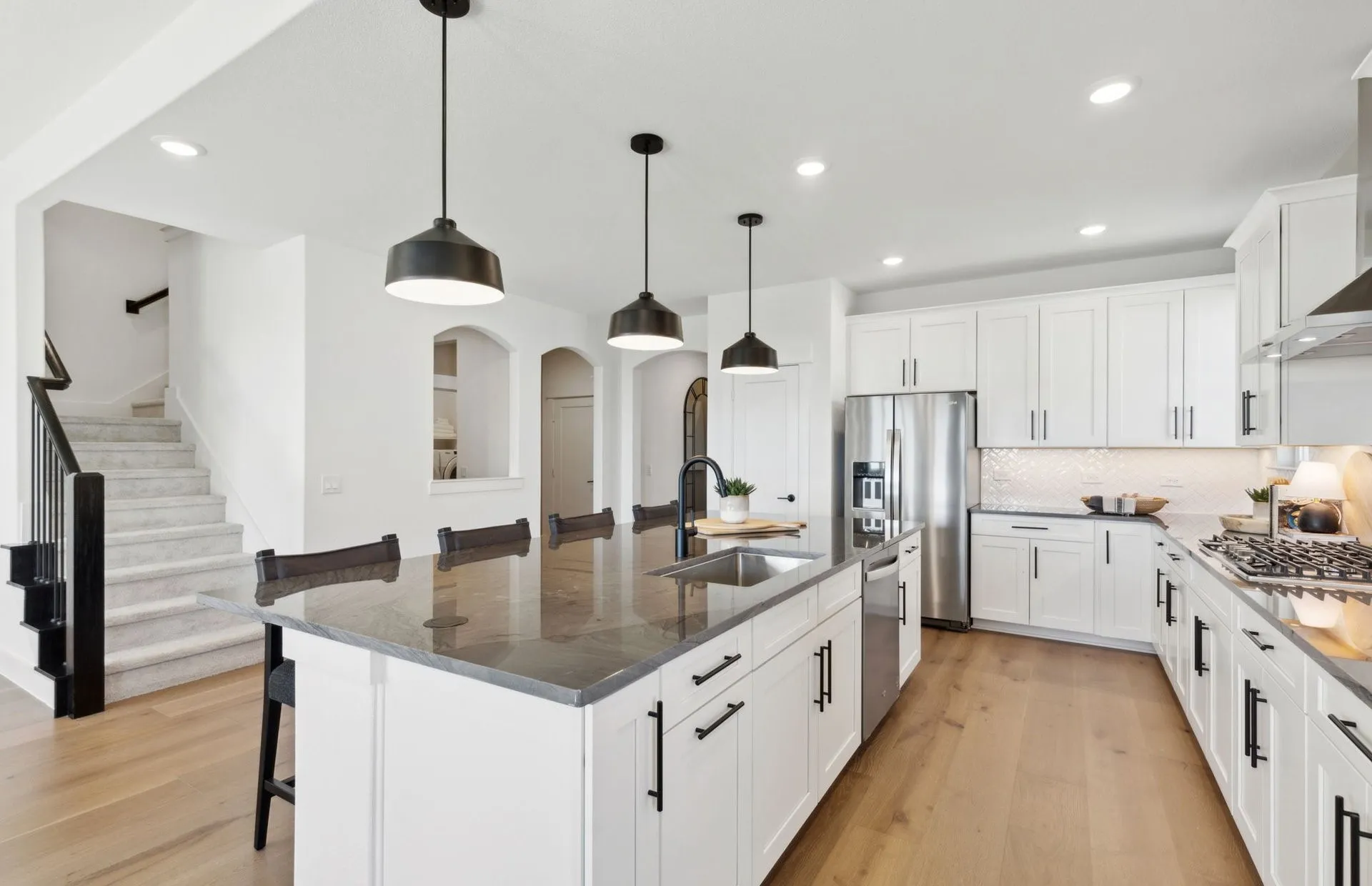 *Model Representation - Large island overlooking gathering room and dining areas