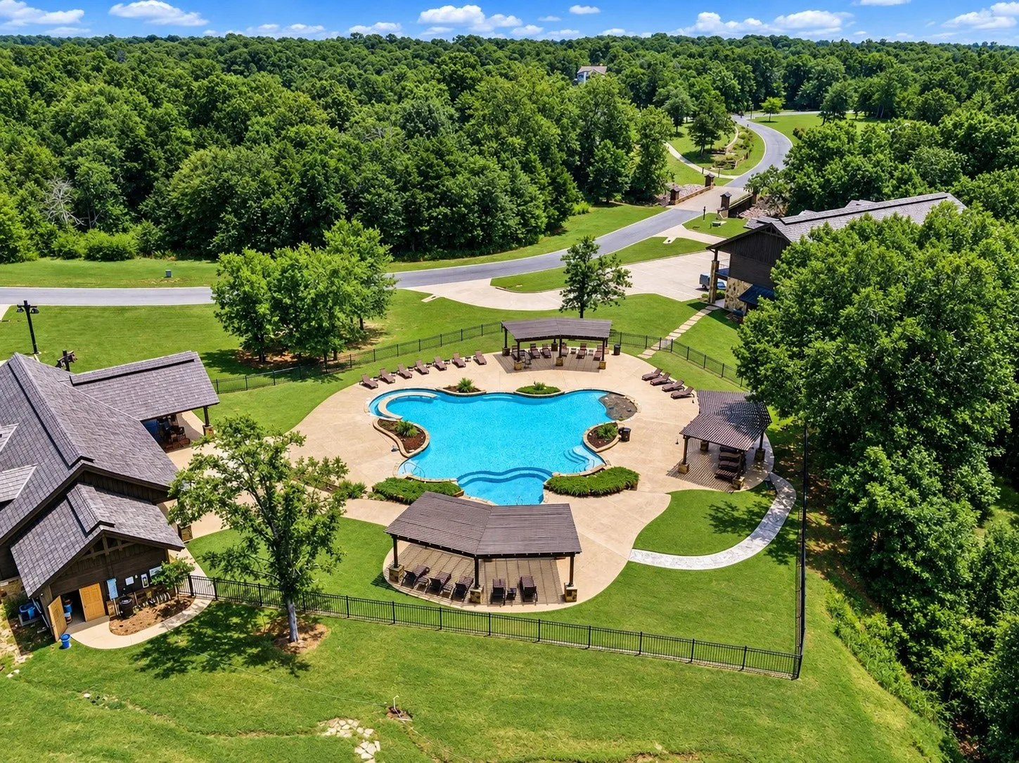Resort-style pool with integrated steps, surrounding lounge areas, and covered cabanas