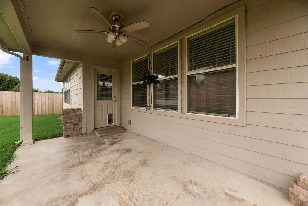 Covered patio with a ceiling fan and integrated lighting fixture