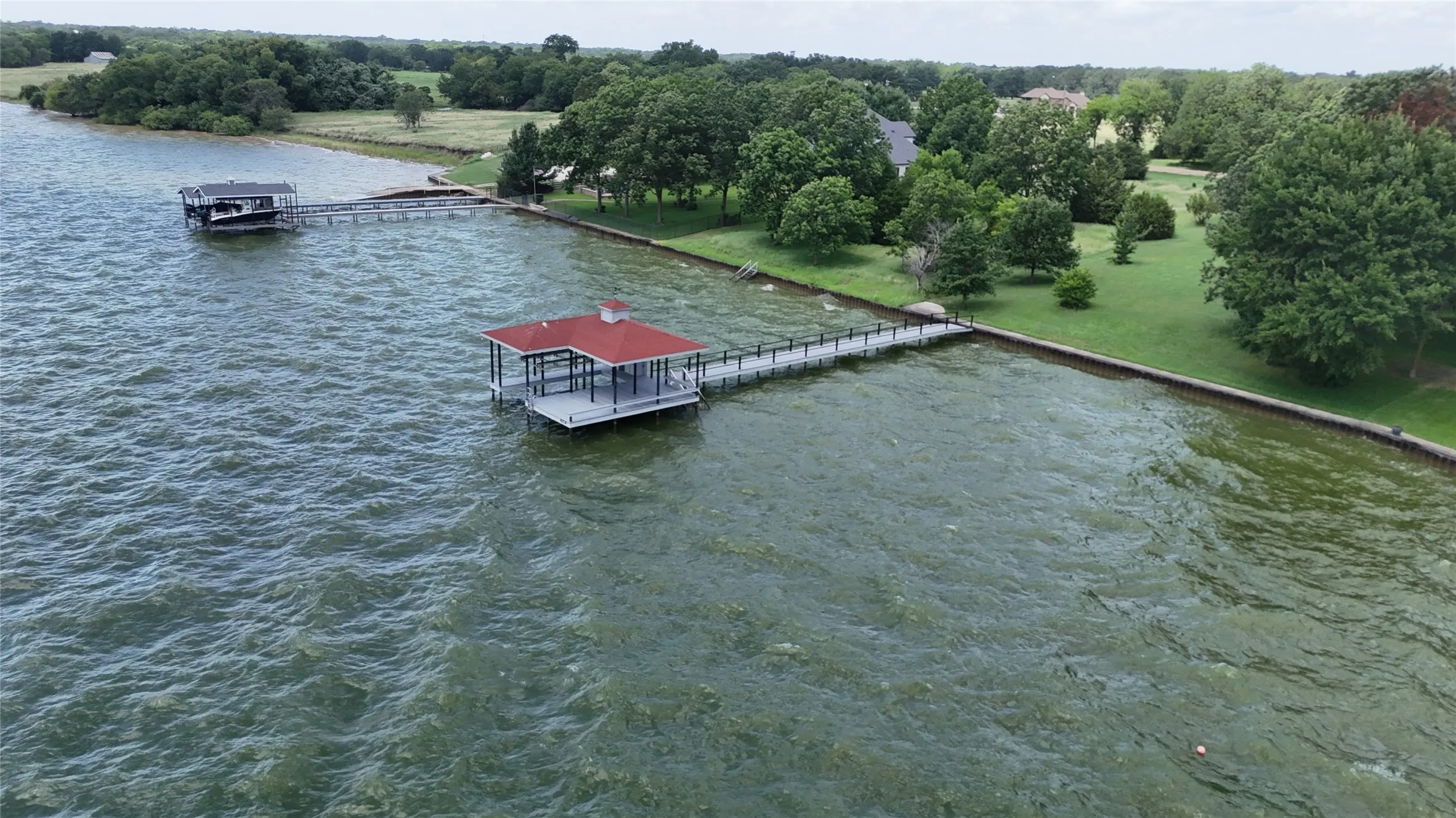 Custom 900-square-foot boathouse built by David Kyle Builders offers direct access to spectacular open water views.