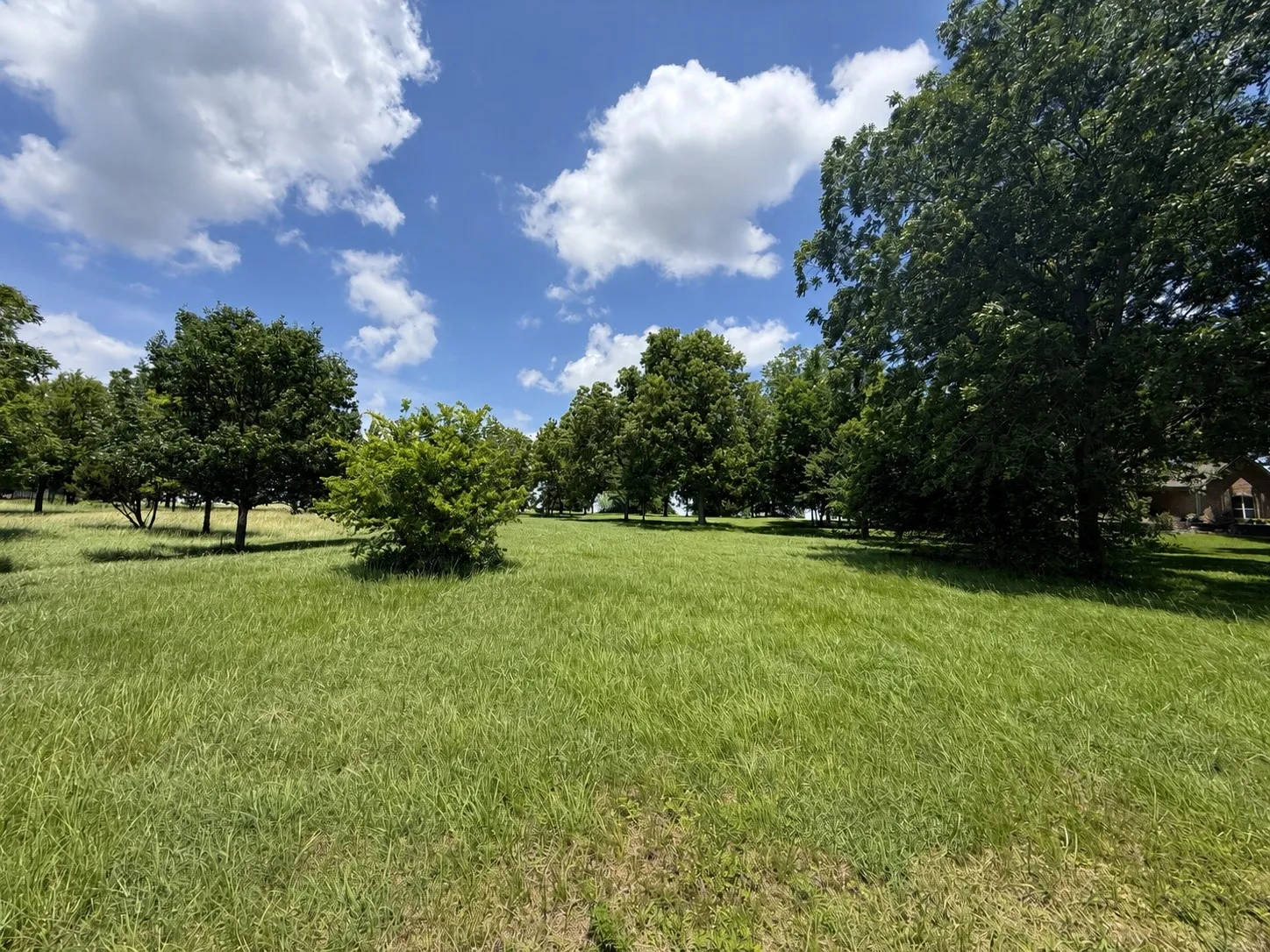 A park-like landscape creates a peaceful atmosphere just steps from the shoreline.