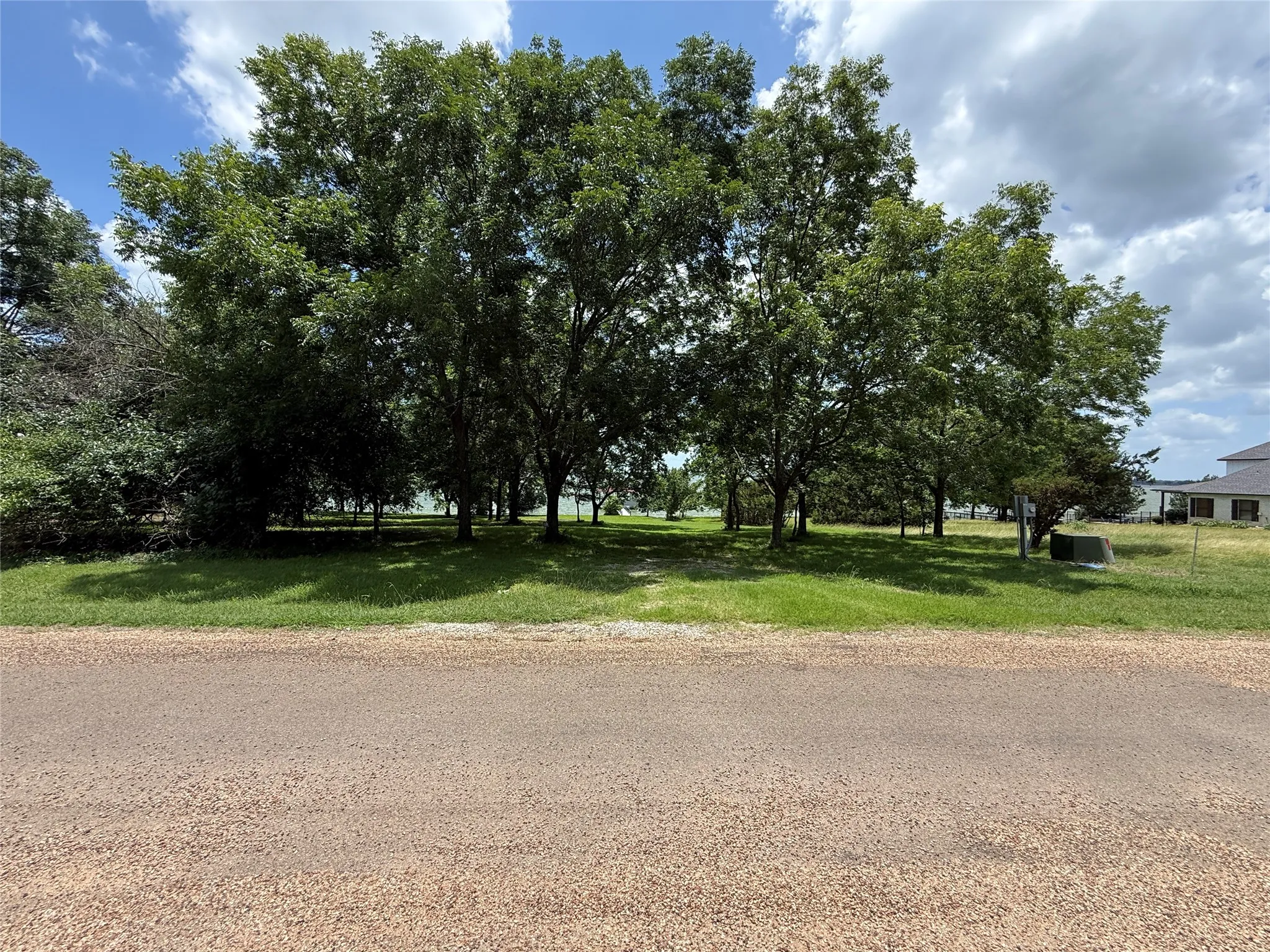 Quiet paved road frontage welcomes you to this heavily treed waterfront homesite in Arrowhead.