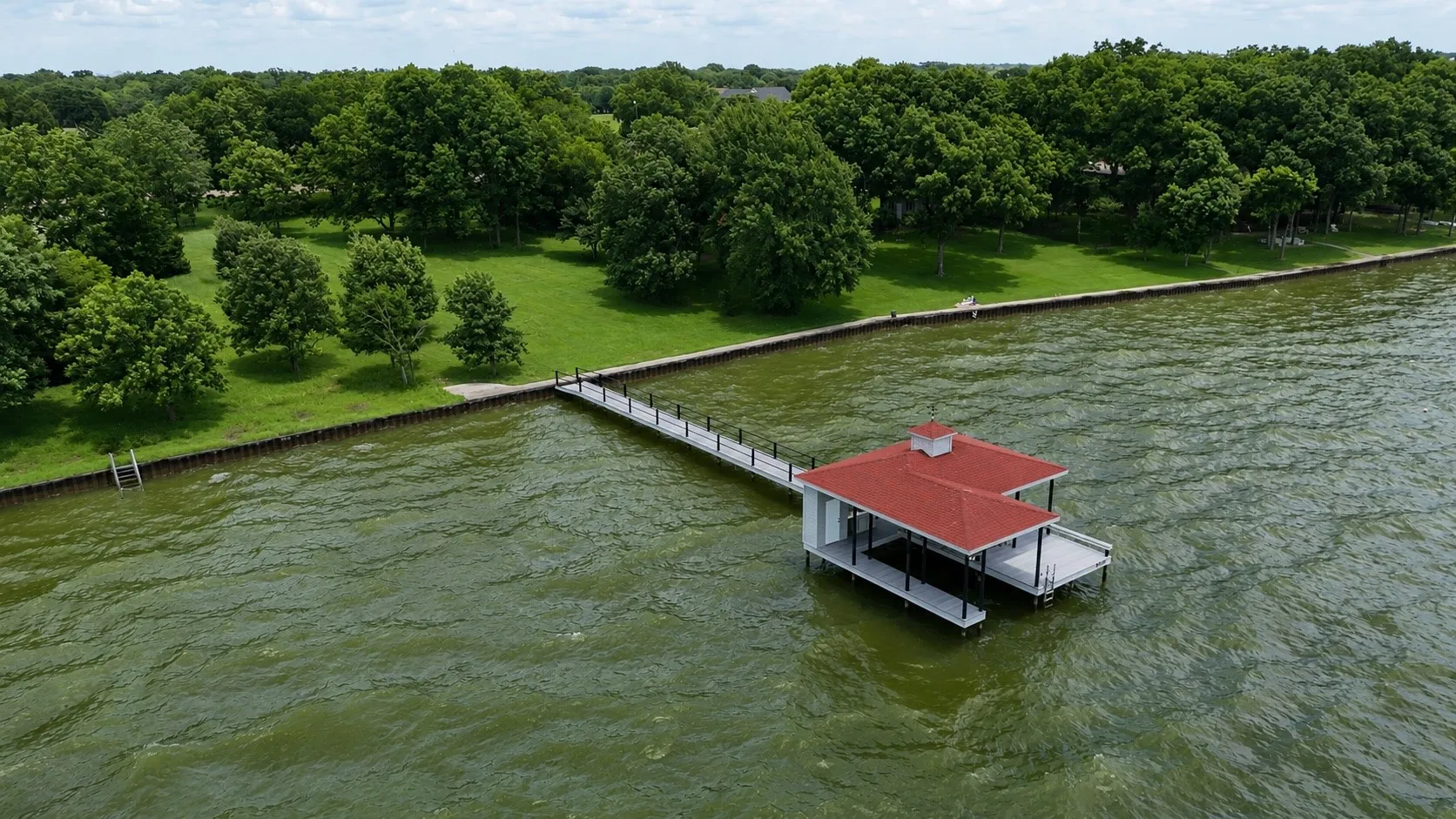 Enjoy lakefront living with a protected shoreline improved by a steel retaining wall and concrete walkway.