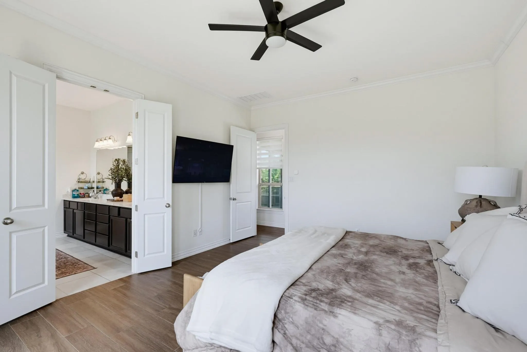 Bedroom with wood-finish flooring and a ceiling fan